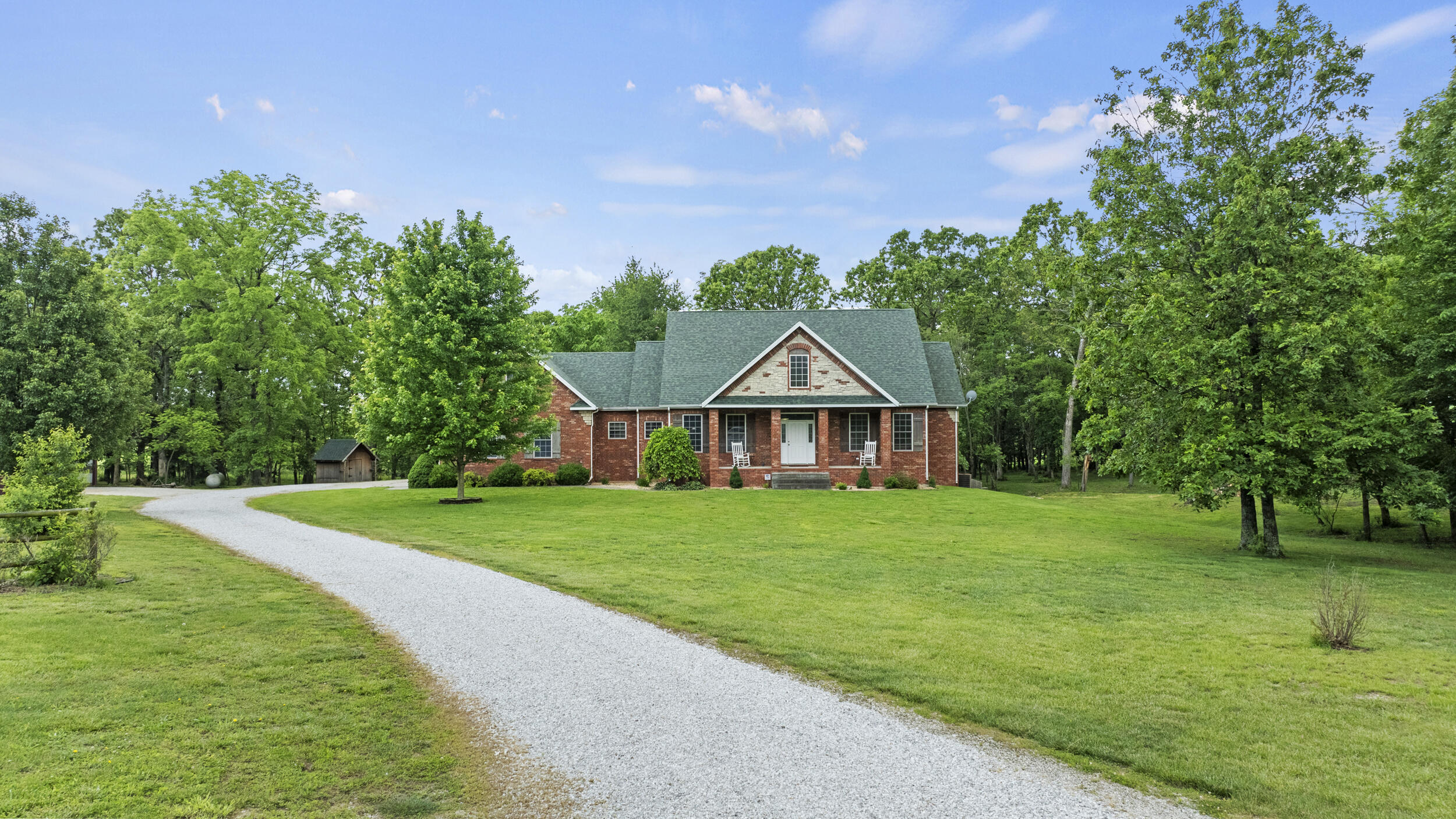 This all brick home on 10 acres features over 4000 sq ft of living space perfectly laid out for your family. It is located just minutes from town, shopping and school. The large open kitchen is an entertainers dream with a large center island, granite counter tops, and an abundance of cabinets and counter space. There is a breakfast nook as well as a formal dining room. The spacious master suite boasts a jetted tub, large walk-in shower and dual vanities. There is a second bedroom and another full bathroom on the main floor. In the basement you'll find a spacious living space, 2 bedrooms, a full bathroom and a large storage area. You'll love spending your summer grilling on the huge back deck and taking in your peaceful surroundings! In addition to the incredible home, this property has 2 shops! One shop is is 30x60 and includes a 945 sq ft in-laws quarters with 2 bedrooms, a kitchenette, full bathroom and an office. The suite could be rented out for a source of extra income.  Or the area would be perfect office space and storage to have a business out of your home. The second shop is 36x40. There is also a she shed and a 24x30 RV carport. There truly is room for the WHOLE family here along with income making possibilities. Call today for your private showing.