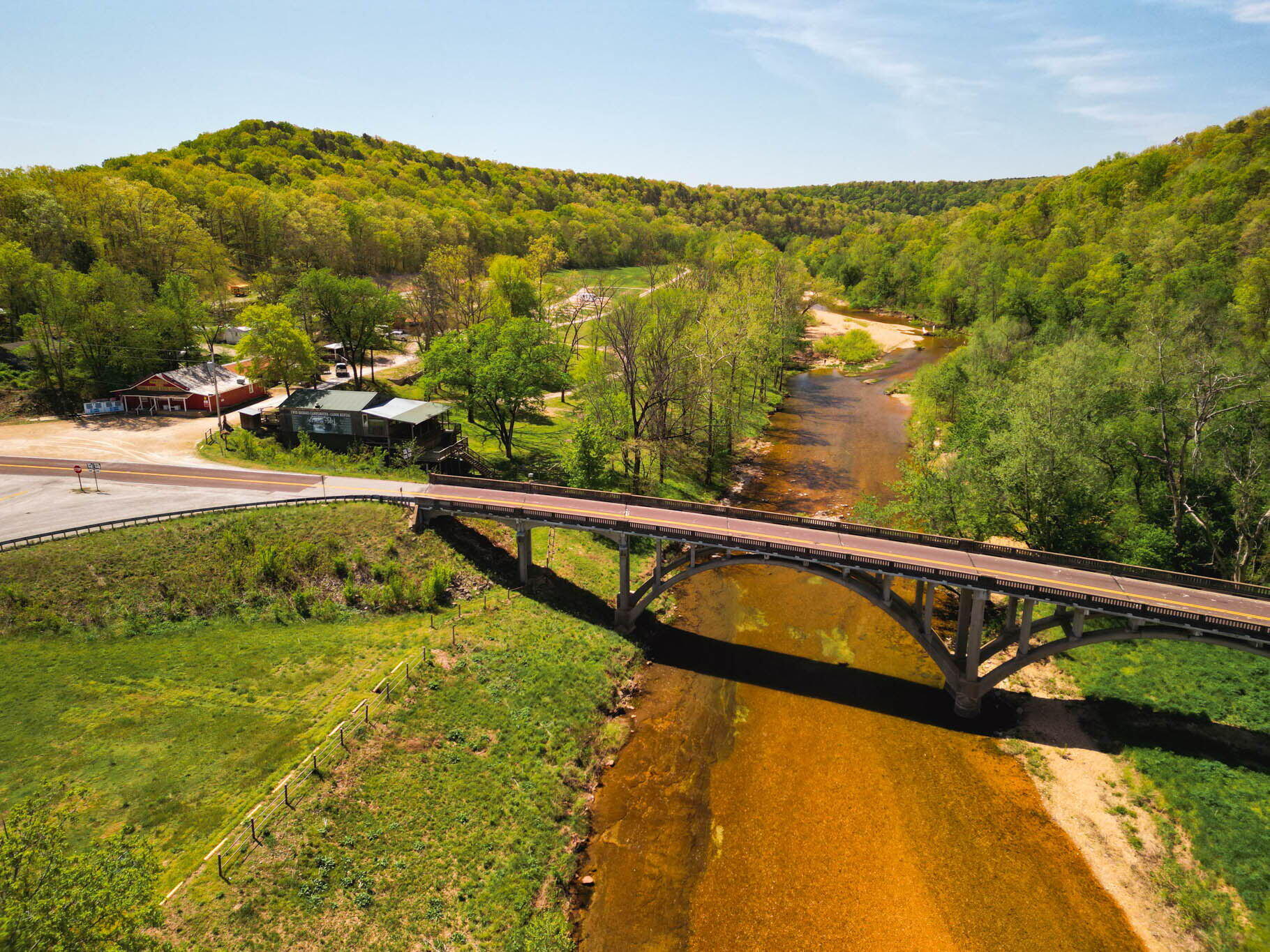 Investment & Income-Producing Opportunity at North Fork of the White River at Twin BridgeExplore a truly exceptional opportunity to own a one-of-a-kind, income-generating property spanning 36.42 breathtaking acres at Twin Bridges. This unique estate boasts approximately 1/2 mile of river-frontage along the crystal-clear North Fork of the White River, a renowned trophy trout river. With its spring-fed waters and rich biodiversity, the river is a paradise for fishing, kayaking, swimming, and canoeing enthusiasts. Additionally, the property features Spring Creek, enhancing the natural beauty and functionality of this Ozarks retreat.Key Features:Multiple Income Streams: This property is a hub of opportunity featuring a restaurant, a general store, a canoe rental business, 28-pad RV park with public restrooms, and multiple residences. These amenities create a built-in revenue base with potential for expansion, catering to the growing demand for outdoor recreation and hospitality services.Prime Riverfront Location: The North Fork of the White River is a sought-after destination for trophy trout fishing, canoeing, kayaking, and river swimming. Its pristine waters attract nature lovers and adventurers, making this property a magnet for tourists and recreational visitors.Outdoor Paradise: With close access to Mark Twain National Forest, this property is a gateway to hundreds of miles of hiking trails, wildlife habitats, and hunting grounds. Whether for personal enjoyment or tourism development, this proximity amplifies the land's value.Exceptional Facilities: The RV Park includes public restrooms, making it an ideal stop for travelers and campers. With the infrastructure already in place this property can support growth in glamping, camping, or eco-tourism ventures.