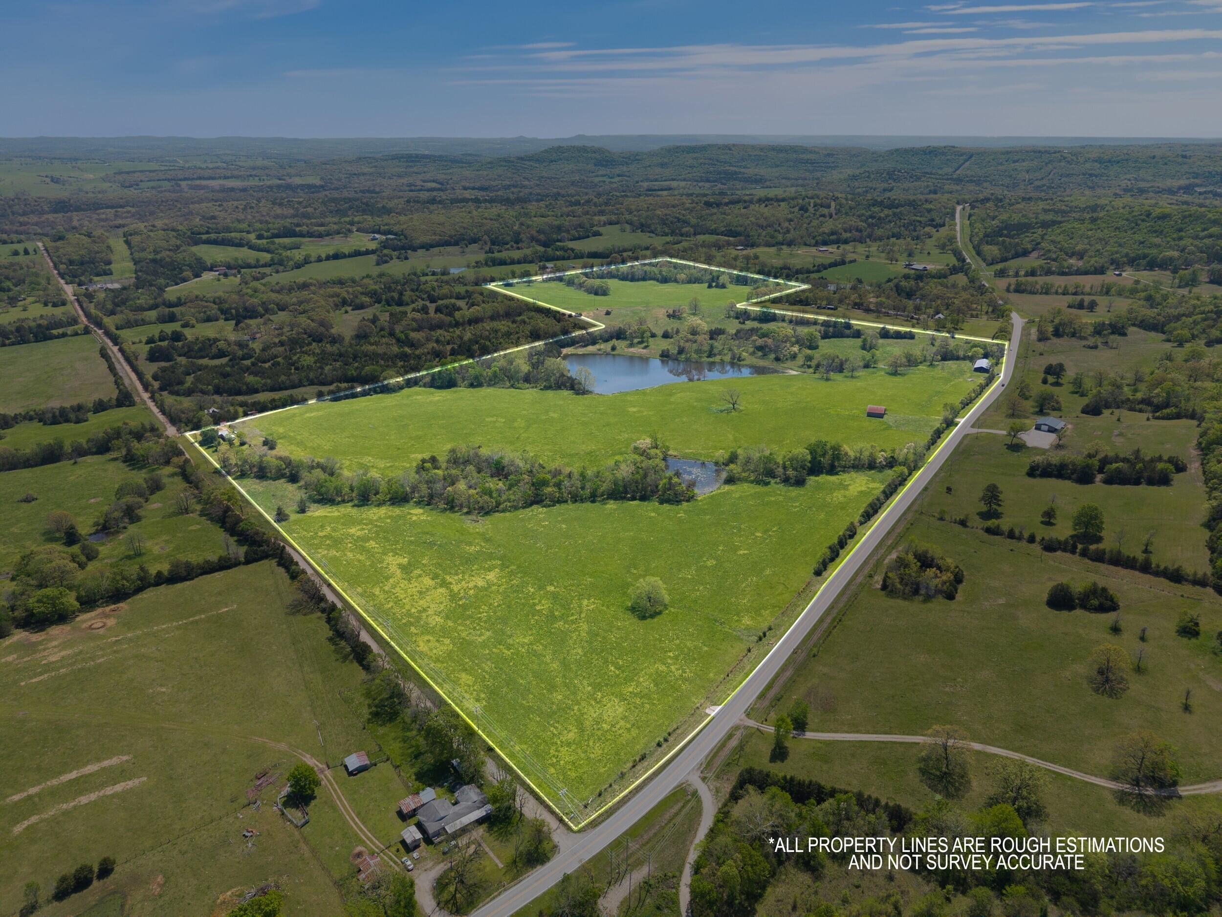 Discover 112 acres of pristine Ozark countryside--gently rolling hills, fenced and cross-fenced pasture, and a private, fish-stocked pond. Just minutes from Table Rock Lake and Eureka Springs, and a short drive to Branson or Bentonville, this land offers beautiful countryside views, peace, and potential. Part cleared and part wooded, it's ideal for gardens, orchards, or livestock. Includes an older barn and functional hay barn. Perfect for grazing cattle, building your dream home, or creating a rustic retreat. The hillside overlooks ponds and distant barns, blending Americana charm with natural beauty. Whether you seek a retirement haven, a second vacation home, or sustainable living, this property offers room to breathe and endless possibilities--country living at its best in the heart of the Ozarks.