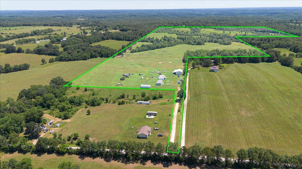 131+/- acres pasture fenced and cross fenced with frost free rural water located at the corrals. Add a package of 2 mobile homes built in 2020. Each having 3 bedrooms 2 bathrooms. The Shop is a dream. 40x50x16 with 14 ft doors, one at the front and one at the back so you can drive through. Spray foam insulated, wired for an air compressor and has water inside. This shop also has 16 x 50 ft overhang on the side of the building. There are 2 whole house generators ready to be hooked up. Propane tank in place. There is a spring that feeds the pond and you have rural water for the corral area. The roads are paved, easy commute to NWA or Joplin.