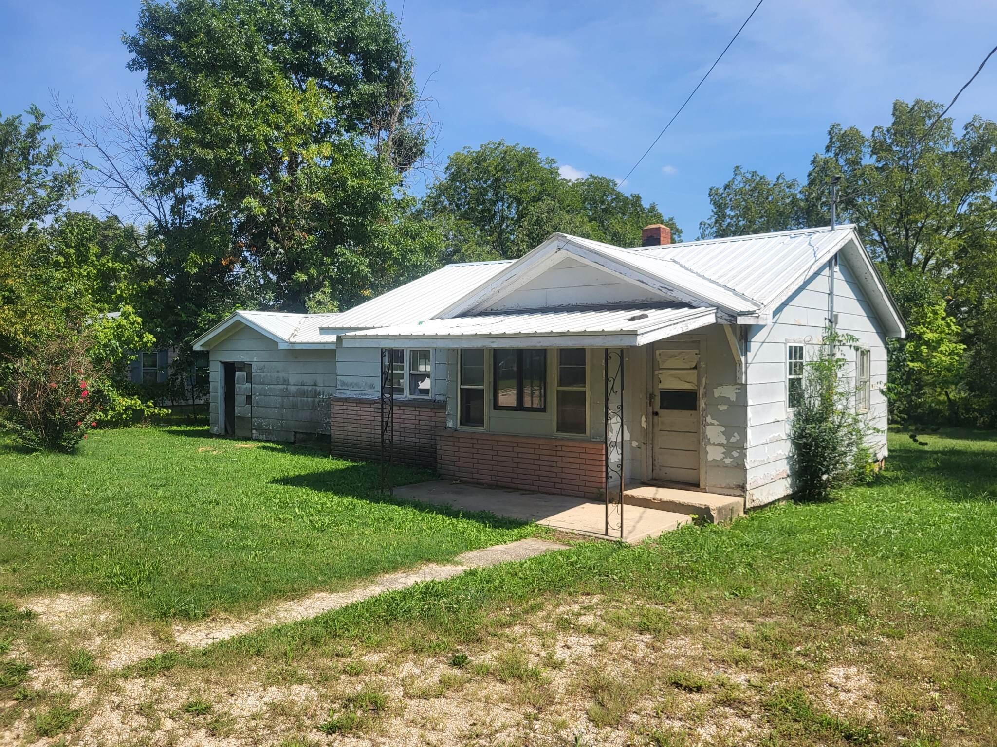OWNER FINANCE !!!!!!!!!! Home with good bones but will need some TLC!!!!!!!!!! House sits on Double lot and offers 3 Bed and 1 Bath floor plan. Just up the road from streams to float and fish the day away. Owner would prefer 25% Down / 10% Interest / 10 Year Payout. Call today and lets make a deal!!!!!! Double lot, Metal Roof, New floor coverings, Small Garage, Place for a wood stove. Contract for DEED possible!!!!!!!!!!!