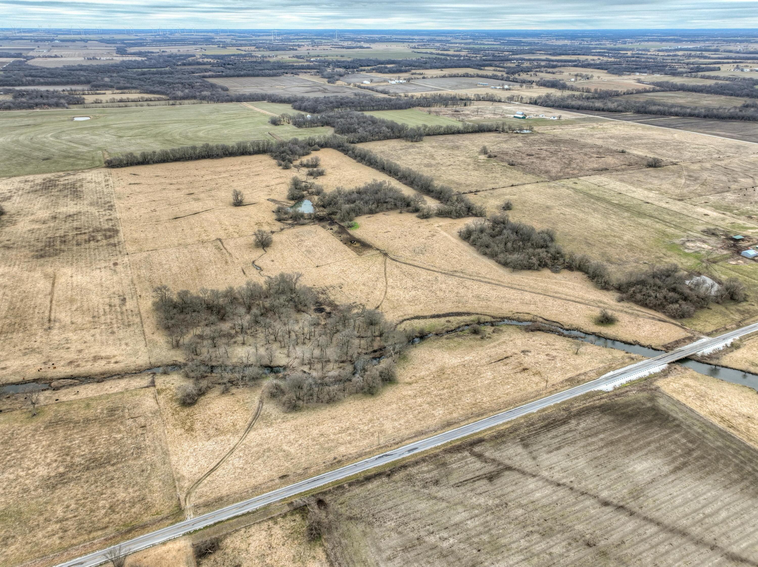 Discover a rare opportunity to own a slice of Missouri's heartland with this exceptional 240-acre farm in Eastern Jasper County. This prime farmland, divided into two parcels of 160 acres and 80 acres, offers a unique blend of productive, tillable ground, lush pasture and recreational potential. Both parcels benefit from the convenience of rural water with hydrants - a valuable asset for any farming operation. The larger 160-acre tract is thoughtfully fenced and cross-fenced, boasting 97 acres of rich, tillable land ready for cultivation, along with over 60 acres of established pasture and a small, picturesque one-acre wooded area. A new survey will be provided by the sellers, clarifying the boundaries of this parcel, which currently comprises the South 160 acres of a larger 320-acre tract. For the avid outdoorsman, an additional80-acre parcel directly across County Road 80 presents an ideal hunting retreat. This diverse tract features a tranquil pond, a meandering wet weather creek and 20 acres of mature timber, creating a haven for wildlife. The property's 60 acres of pasture also include a functional working corral, adding to its appeal for livestock operations. This remarkable property, with its combination of productive farmland, convenient amenities and recreational opportunities, is a must-see for discerning buyers!