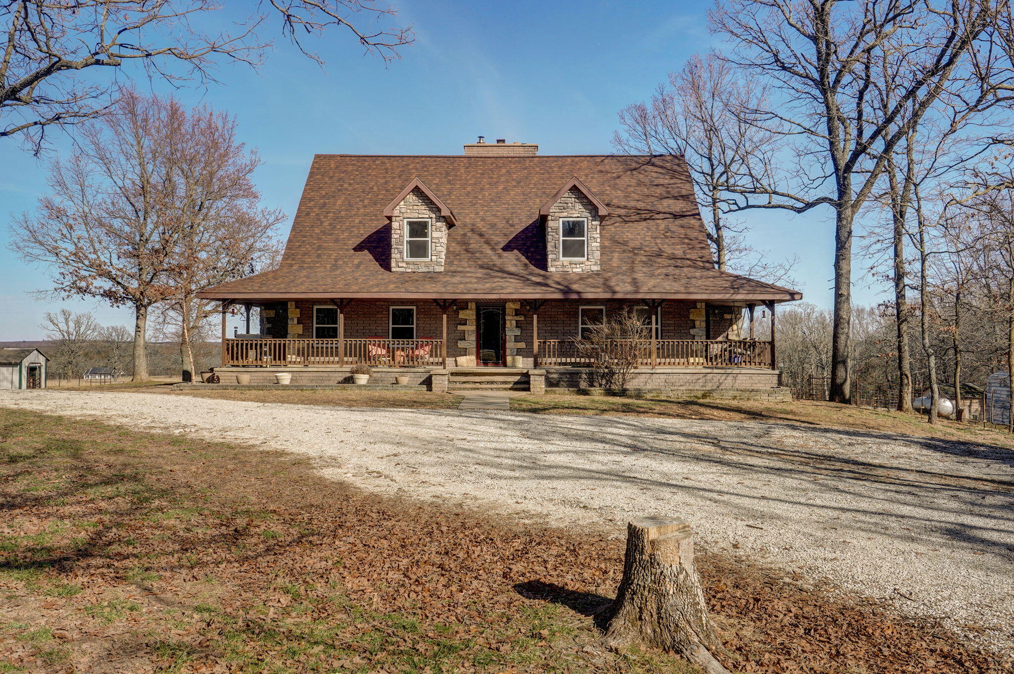 Charming Craftsman-Style Home on 10 Acres with Walk-Out Basement and Established Chicken HouseNestled on a sprawling 10-acre corner lot, this beautiful craftsman-style home offers the perfect blend of comfort, style, and functionality. Featuring a large wraparound front porch, this home invites you to enjoy the scenic surroundings and peaceful countryside.With 4 spacious bedrooms and 2.5 bathrooms, this home is designed for country living. The stunning hardwood floors throughout add a touch of elegance, while the wood furnace, integrated into the ductwork, provides cozy warmth throughout the entire home. For added peace of mind, a propane forced-air furnace serves as a backup, ensuring year-round comfort.The walk-out basement is fully finished and offers versatile living space--perfect for a rec room, theater room, or anything that suits your lifestyle. The basement's layout is designed to adapt to your needs.This property comes complete with an established chicken house, cattle corral system perfect for those seeking a homestead-style lifestyle. Whether you're raising poultry, gardening, or simply enjoying the space, this feature adds to the charm and potential of the property.The land is fully fenced and cross-fenced, ideal for livestock or simply enjoying the wide-open space. Whether you're looking for a tranquil retreat or a family-friendly home with room to grow, this property offers endless possibilities.