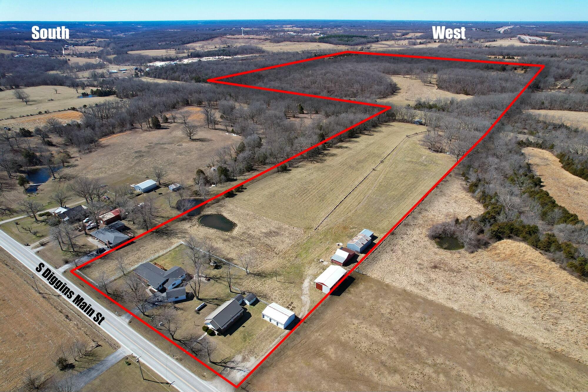 Discover the perfect blend of space, privacy, and charm with this stunning property featuring two homes nestled on just over 83 acres of picturesque land. A paved private drive welcomes you to the main home, boasting over 2,000 sq ft of living space, a covered front porch, and a detached garage. Inside, you'll find 3 bedrooms, 3 bathrooms, and plenty of room to entertain. Step outside to relax on the large deck or enjoy peaceful moments in the gazebo, all overlooking the sprawling yard.Next door, the second home offers over 1,000 sq ft of cozy living space with 2 bedrooms, 1 bathroom, and a detached 3-car garage.The land itself is a dream, featuring a spring-fed creek, two ponds, and multiple barns, offering endless possibilities for farming, livestock, or recreation. Whether you're seeking a private retreat or an investment opportunity, this incredible property is a rare find. Don't miss your chance to own this slice of paradise in Seymour!