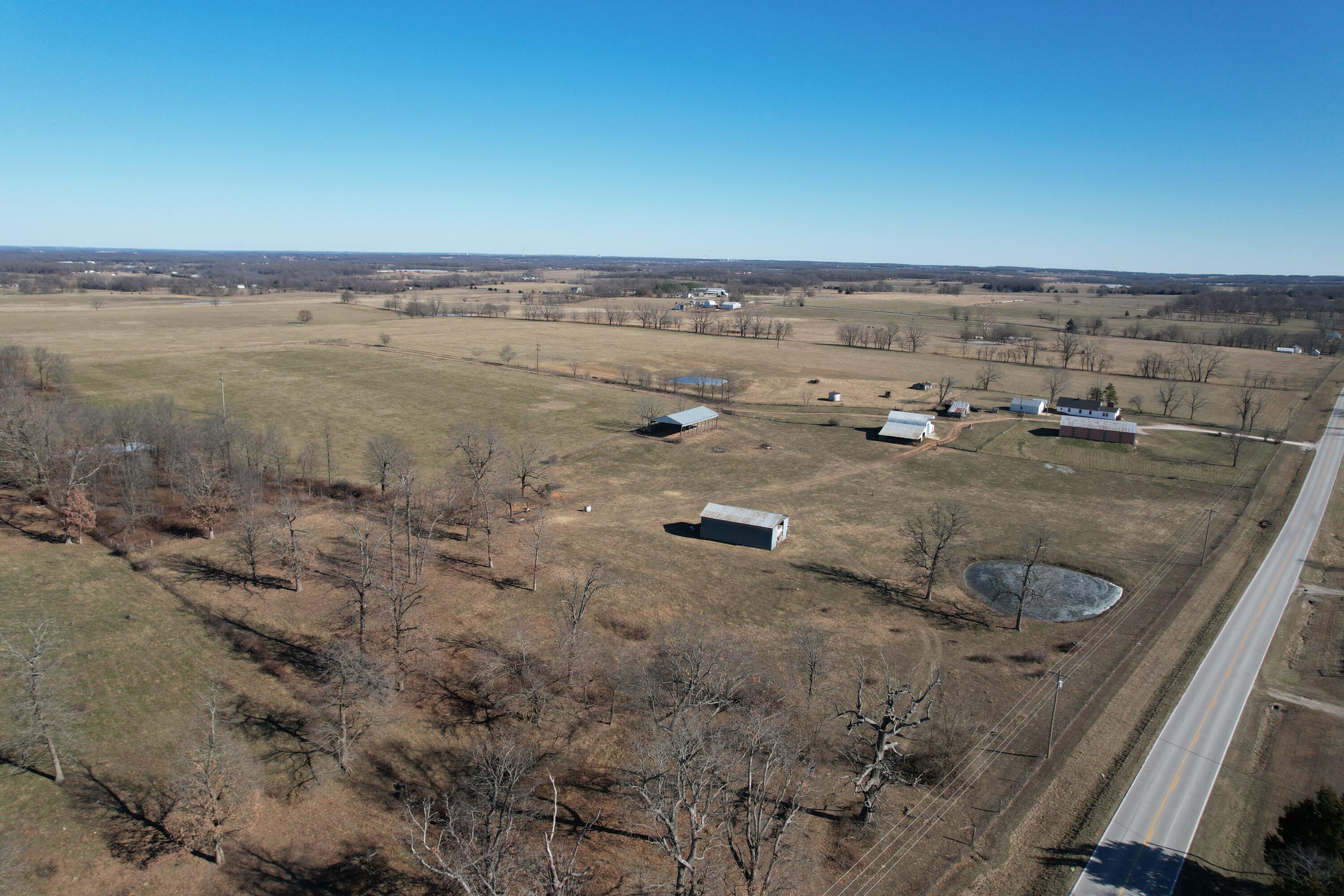 Check out this 280+/- acre cattle farm outside Monett, Missouri!  The farm is now available on the market for the very first time and has so much to offer. Fully fenced and cross-fenced, the property features multiple paddocks for rotational grazing and optimal land management. Highly productive hay fields, 10 well-placed ponds, and five cattle waterers provide ample resources to support a thriving herd year-round. Located on State Highway Z, halfway between Monett and Aurora, this farm offers the perfect balance of seclusion and accessibility. Additional features include two homes (currently rented), detached two-car garage, a shop, older barn, multiple other outbuildings, and a cattle working facility. The cattle waterers are tied into a well located on the east side of the farm and the houses have their own wells. This farm is a must see, whether you're looking to settle in Missouri or add to your existing operation!