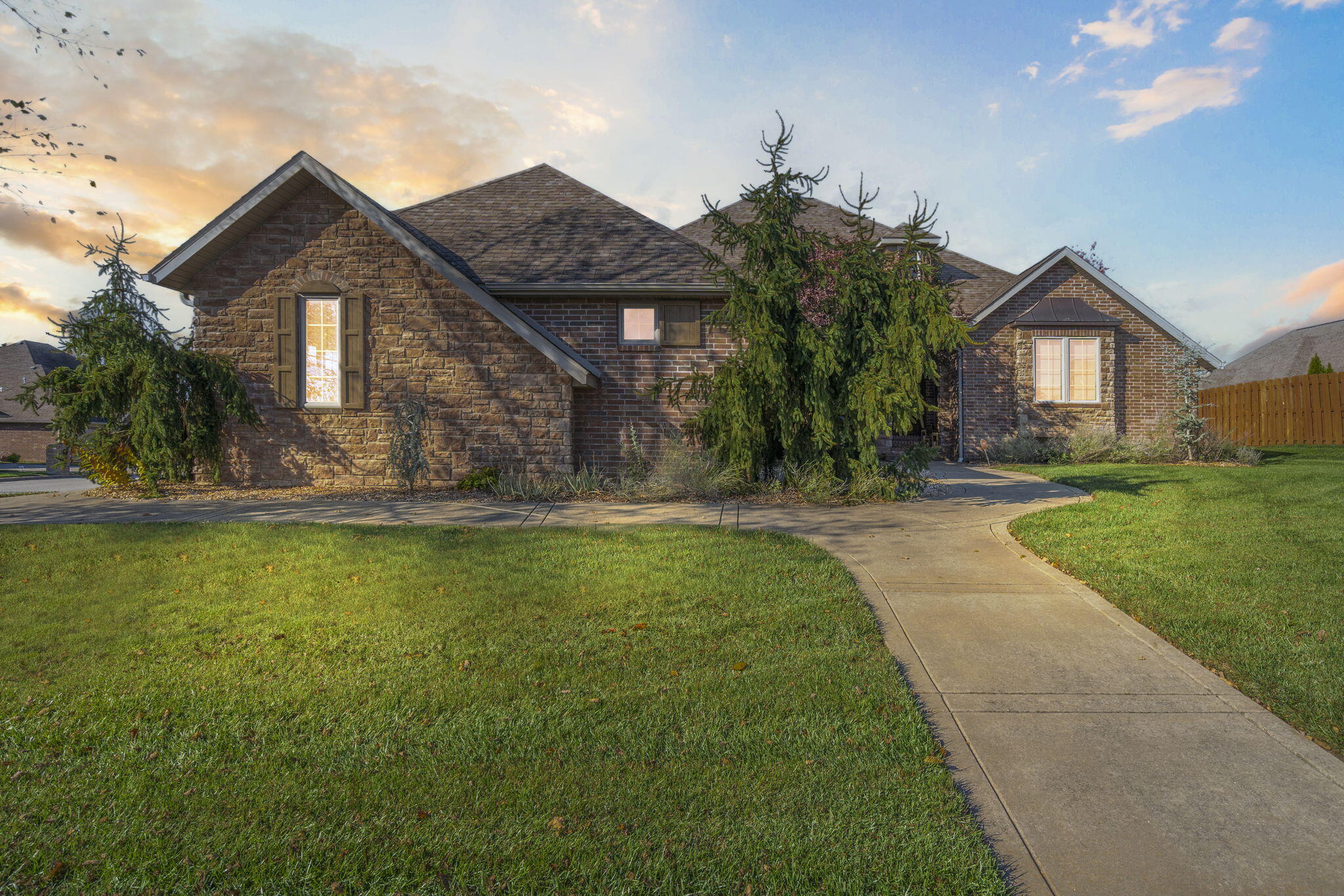This stunning all-brick basement home provides the perfect blend of style and space. The main floor is over 2800 square feet and you will find four spacious bedrooms, or 3 bedrooms and a dedicated office,  plus two full bathrooms, ideal for multiple people and those who work from home. The primary bedroom includes a spa like bathroom and walk in closet plus a back porch access. Your first floor also includes a chef's kitchen, walk in pantry plus a mudroom connected to a garage access mudroom.Downstairs, the layout expands with an additional bedroom, two family rooms, and a third full bathroom, creating a versatile space perfect for guests, entertaining, or a cozy retreat.The home's interior shines with hardwood floors and granite countertops, bringing warmth and sophistication to every room. Outside, enjoy the screened-in back porch, surrounded by beautiful landscaping that enhances the corner lot's curb appeal. With a three-car garage conveniently located on the side featuring brand new, custom garage doors, this home is designed for comfort, luxury, and practicality in every detail.