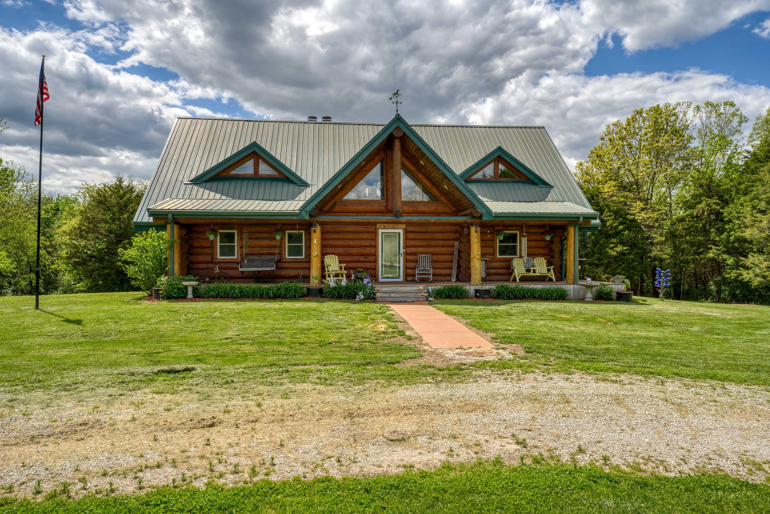 Nestled on 40 M/L sprawling acres in Chilhowee, MO, this one-of-a-kind log cabin is a true paradise. With 3 spacious bedrooms,3.5 baths, and a full walk-out basement featuring a single car garage, it offers plenty of room for both relaxation and adventure. The rustic charm of the cabin is complemented by two cozy fireplaces, and outdoor wood-burning heat, ideal for those chilly nights. The property is a dream for animal lovers, with a horse barn and fenced areas providing ample space for your furry companions to roam. A secluded pond add to the tranquility, while abundant wildlife surrounds you, creating the perfect backdrop for nature enthusiasts and hunters alike. The Rock Island Trail runs along the edge of the property giving easy access to walk or ride your bike down the trail. This home combines seclusion with modern convenience, making it the perfect retreat for anyone looking to embrace country living while only being 15 minutes away from Warrensburg and Clinton, and only 40 minutes away from Harrisonville. With its mix of beauty, functionality, and adventure, this property offers something truly special. An Additional 35 acres M/L is available.