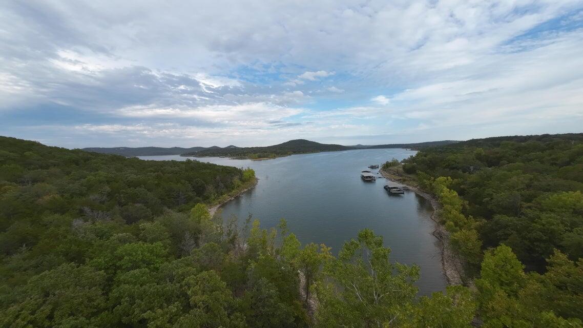 Stunning lake frontage RV Park, a well-established and thriving RV destination near the picturesque Table Rock Lake. This 76-unit campground, including 16 brand-new sites, is designed to blend seamlessly into nature while providing modern conveniences and comfort. With breathtaking lake views and 14 acres of lakefront, guests can enjoy the serenity of nature while still having access to the lake.Designed for convenience, the campground features easy pull-in and pull through access for RVs of all sizes. Visitors will appreciate the extremely clean and spacious shower house with private stalls and on-site laundry facilities. The state-approved private well system ensures peace of mind for the new owners. A community septic system and well-maintained roads further enhance the park's infrastructure. With an established clientele and full-time tenants occupying the property, help the occupancy rate for more assured tenant income.  This is a proven and profitable RV park with room to expand.Beyond the park's charm is the well designed and reliable infrastructure., Its prime location makes it even more attractive. It is just minutes from Table Rock Lake, making it an ideal destination for fishing, boating, and water sports enthusiasts. It is also just up the road from Campbell Point Marina, one of the most popular marinas, with a boat launch is just down the road, allowing guests to hit the water with ease. Additionally, the park is conveniently located by a gas station, providing quick access to snacks, food, and propane.With ample lakefront land for expansion, this property offers endless potential to grow your vision. Whether you're an investor looking for a turnkey business opportunity or an outdoor enthusiast dreaming of running your own RV paradise.  Area71 RV Park is the perfect choice. Don't miss out on this established, well-maintained, and profitable campground in one of the most sought-after lake destinations on glorious Table Rock Lake frontage.