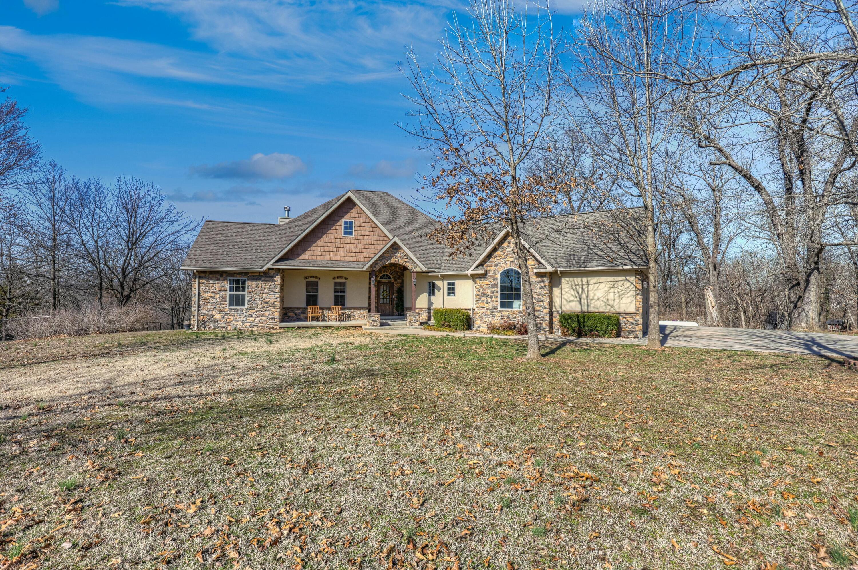 You don't want to miss this beautifully crafted home on nearly 3 acres with views of Spring River! Your new home features hickory hand-scraped hardwoods, an expansive kitchen with eat at barn, granite countertops, and stainless steel appliances. 3 large bedrooms on the main level plus bonus room and finished basement with additional kitchen and bedroom, and great room perfect for entertaining! Ample storage throughout including extra large utility room. Third garage space in basement. Tucked away with a private setting, beautiful views on quiet cul-de-sac street. Schedule a personal tour today!