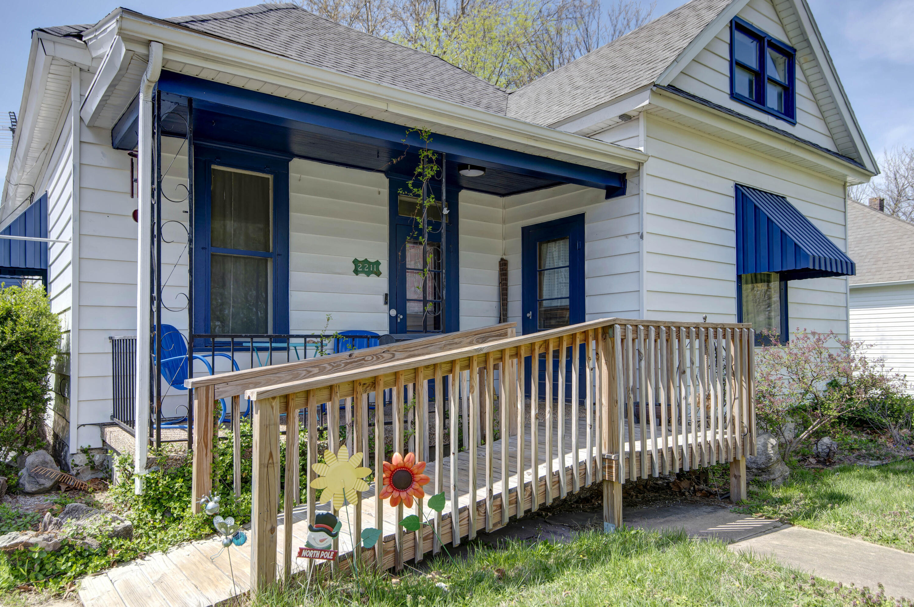 Charming, turn-of-the-century home with a welcoming covered front porch and convenient ramp for easy accessibility! This delightful 2-bedroom, 1-bathroom home has tall ceilings, hardwood floors, and a spacious kitchen filled with character and timeless charm. The main floor master bedroom is large with two closets and built-in drawers. You'll appreciate the updated bathroom with new walk-in shower. Step outside to a large backyard with a new accessible deck, perfect for relaxing or entertaining. Enjoy direct access to the 1-car garage from the alleyway, plus additional car port parking, and a small shop building.