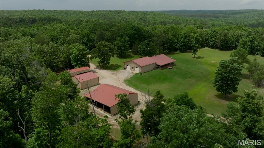 1356-Acre +/- Hunting Paradise in Southeast Missouri. Located just 30 minutes from Poplar Bluff, MO, this 1356-acre +/- property is a hunter's dream. Set up for whitetail and turkey hunting, it features miles of accessible trails, 30+ food plots, and two creeks. The majority of the land is timber, thinned, and managed for optimal wildlife movement. The property borders government ground, providing extra privacy and hunting opportunities. A rustic 4-bed, 2-bath lodge offers a cozy retreat, while multiple outbuildings provide ample storage. Included are blinds, feeders, and equipment, making this a turn-key hunting retreat. With rolling hills, bottomlands, and diverse wildlife habitat, this property is perfect for those seeking an exclusive Ozarks hunting experience. Properties of this size do not come on the market very often, but you have the chance to own land for yourself and generations. Contact us today to schedule a private tour!