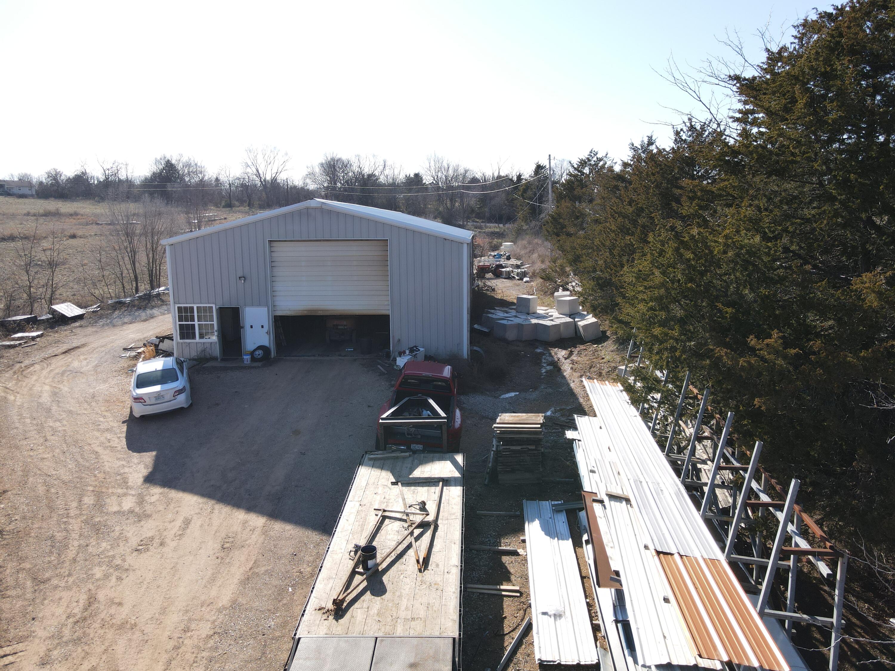 TURN KEY BUSINESS! High Cap Rate! Collier's Boat Dock Manufacturing Inc. has been operating in the Table Rock Lake area for fifty-seven years. It is located on State Hwy. H near Table Rock Lake and is the closest boat dock business to a build site.  Collier's Boat Dock Manufacturing Inc. has a good rapport with the ACOE (Army Corp of Engineers) and has occasionally worked for them. The large red iron building on site houses the dock plant, office, bathroom, and an overhead apartment/office space. The 8.1 acres surrounding the building are convenient and provides plenty of space for storing inventory used in the boat dock manufacturing business.  Water well and septic is found on the property. The prime location of the business near a build site on Table Rock Lake bids well with the ability to load dock structures on the water saving time and wear/tear on equipment.  A vital and crucial part of this profitable business is the excellent employees. Who have proven themselves many times capable of building/repairing docks without supervision.  Importantly, these remarkable employees are willing to stay with the business.