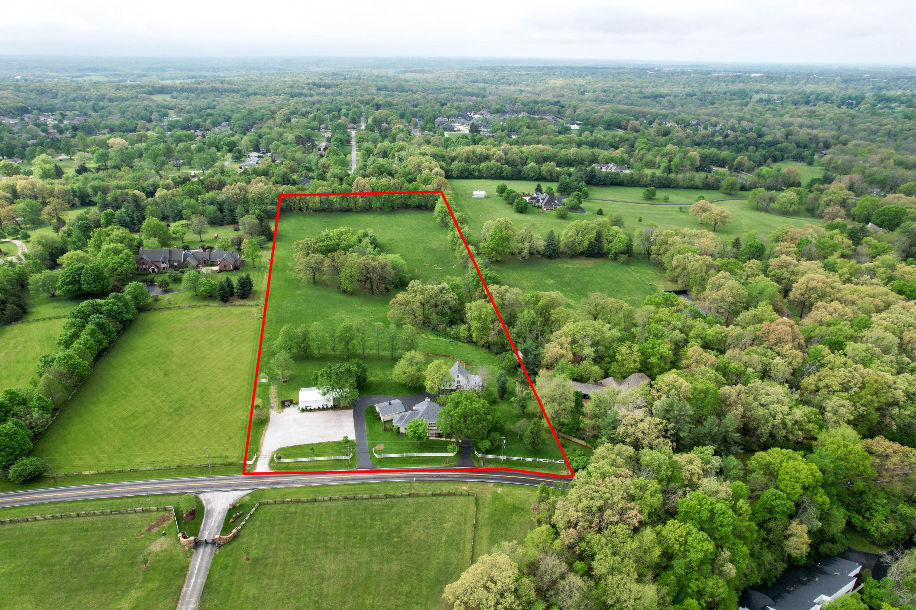 Take advantage of a rare opportunity to own this one-of-a-kind eight-plus-acre estate located in one of the most coveted east Springfield locations - near Pearson Creek on east Mill Street.  This property features park-like private landscapes, perfectly groomed with building sites suited for a walk-out or a one-level house.  The original home, built in the late 1800's, has been updated but retains its inviting cottage farmhouse charm.  The house has a large, first-floor main bedroom with en suite bathroom featuring jetted tub, separate vanities, and a walk-in closet.  The first-floor great room includes an inviting hearth room with fireplace, perfect for relaxing. The kitchen boasts an island, walk-in pantry, and Viking appliances.  Upstairs the two large guest suites each feature walk-in closets and full bathrooms.  This property has THREE functional buildings.In addition to the endearing home, the property has a barn/guest house and a large 30x40 shop.The barn/guest house has a first-floor recreation room, a second-floor kitchen and living area with a full bathroom, and a third-floor bedroom.  The shop has 220 electric services, gas heating, large fans, a covered front driveway with wench, and a double roll-up garage door.The new owner of this estate has many options to take advantage of. Some of which include:1.Live in the farmhouse and enjoy the property, shop and barn.2.Live in the farmhouse while building your estate home on the ready-to-build pristine eight acres of land.3.Build your dream estate home and utilize the current farm house as a guest home for friends and family.