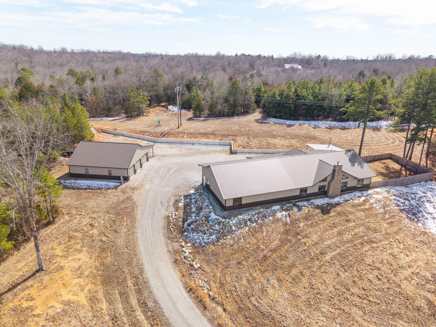 This 56-acre property near Mountain Home, AR, includes a custom-built home on 32 acres and separate additional lots totaling 24 acres. The home sits on 32 acres with a private, stocked lake and features an open-concept design with native stone and cedar accents. The 2-bedroom, 2-bath layout includes a spacious master suite with a walk-in closet, backyard access, and an en-suite with double vanities, a jetted tub, and a custom walk-in shower. All doors and hallways in the home are extra wide making the home accessible. A 3-car garage includes a concrete storm shelter/safe room. Outdoor living is enhanced by a covered entertainment area with a bar, stone fireplace, and hot tub, along with a fenced backyard for added privacy. The 40x40 three-bay shop with a 15-ft lean-to provides ample storage. The stocked lake offers crappie, bass, and bluegill, and the property supports hunting, hiking, and recreational activities. Separate from the home, the additional 24 acres are divided into multiple lots: Lots 20, 21, & 22 (13.87 acres) This provides the perfect investment opportunity. The additional property could be developed into cabins, short term rentals, or even retirement homes. Level and partially wooded with electric available, ideal for building, gardening, or homesteading. Lot 32 (4.63 acres): Partially cleared with electricity, a new well, and a newer septic tank. A privacy-fenced area with a deck is included but can be removed if desired. A leveled site is ready for a home or camper. Lot 18 (4.99 acres): Open and wooded land with electric available, perfect for a home, camping, or recreation. Located 8 minutes from Lake Norfork and 15 minutes from Mountain Home, this property offers a private home with acreage, along with separate tracts for investment, expansion, or additional building opportunities.