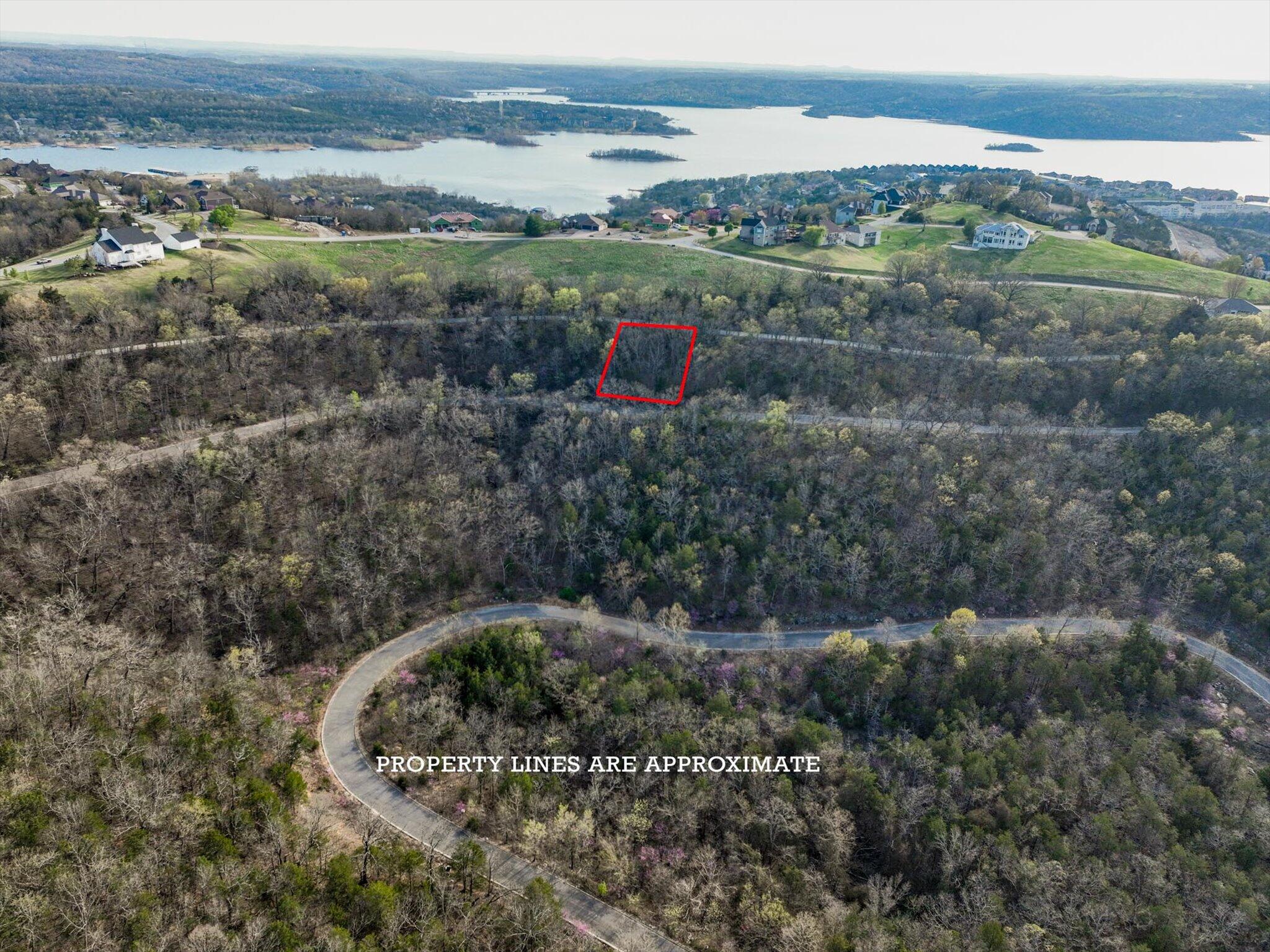 Enjoy the ease of low-maintenance living on this 0.25-acre lot in the gated community of Emerald Pointe. Just minutes from Table Rock Lake and the vibrant attractions of Branson, this homesite offers a great opportunity to build in a peaceful setting without sacrificing convenience. The neighborhood features a clubhouse, swimming pool, tennis courts, and basketball courts, making it easy to stay active and connected. Whether you're ready to build now or planning for the future, this lot is a solid step toward your ideal home.