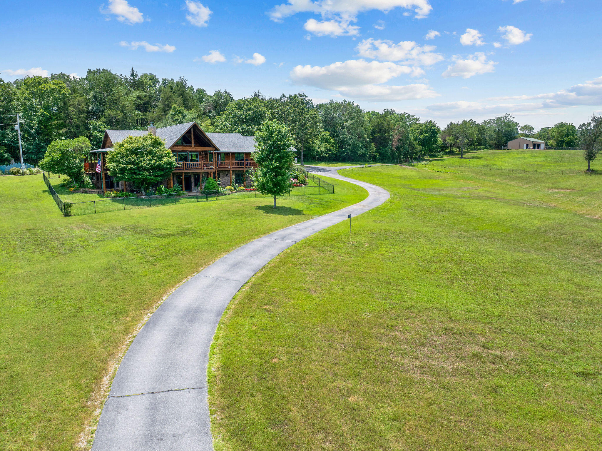 Not often does an estate like this one become available. The full bounty of Ozarks beauty is showcased here and includes 10 acres of the most picturesque land. The 30x40 Shop is also included ! This custom log home is perfectly situated on the 10 acre pristine spread allowing for privacy and peace. Home is lovingly cared for, inviting, relaxing and enchanting. Some of the special features include: Updated Kitchen & baths, custom hardwoods/tile; decks on 3 sides overlooking the Ozarks; Oversized windows with plenty of natural light; Power blinds; Dual Fuel Stove/Convection Oven; Leathered Granite counters; Huge Main Level Laundry; Private Well; 30x40 Shop with Horse Stall; Yard Fence; Invisible pet fence; Wood Beams & ceilings; 2nd Kitchen in Basement; Privacy. All this and more just minutes to fun - Table Rock Lake; Beaver Lake & multiple Lake Accesses / Marinas; Various Shopping locations; Shell Knob, Cassville, Eagle Rock, Eureka Springs - such a great location - Branson is close too. Did I mention the possibility of subdividing for another home? If vacation rental is your desire - check with the county as this is not in a subdivision - Freedom Abounds at this Estate.