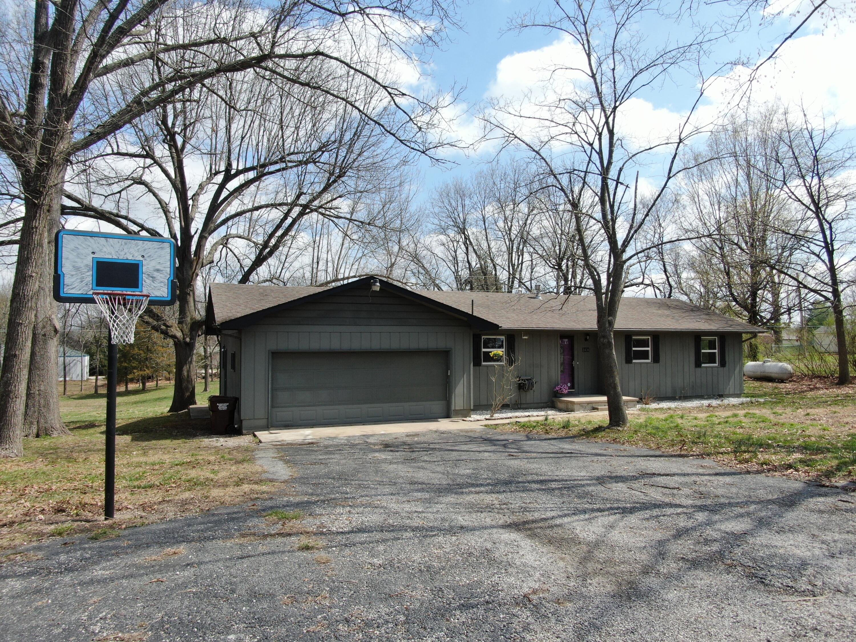 Mainly private 2 acres with a 3 bed, 2 bath home in Nixa Schools. Just 1/3 mile off Main Street on a quiet community lane and just outside of the city limits. Oversize garage with a workshop nook and an outbuilding for extra storage. Large multi-level deck with great views of the outdoors and expansive yard. Partially fenced for pets.
