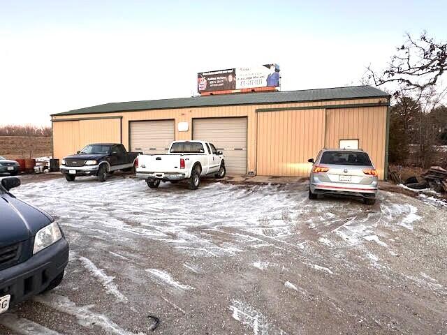 Prime 3.31-acre (m/l), with no restrictions, Location with Excellent Exposure on Highway 60 with a thriving Automotive Repair Business. Original owner since 2007. Walk right in and get to work! This shop features four 14 feet high bays with 12-foot opening doors, two lifts, office, restroom. Property also offers septic, well, electric and ample parking space for clients. Most tools, equipment and shop inventory available at closing. Waste oil heater stays with property providing very cost-effective heating for this prosperous auto repair business! $499,900. Owner says Let's Talk!Also extra income yearly on the billboard sign.