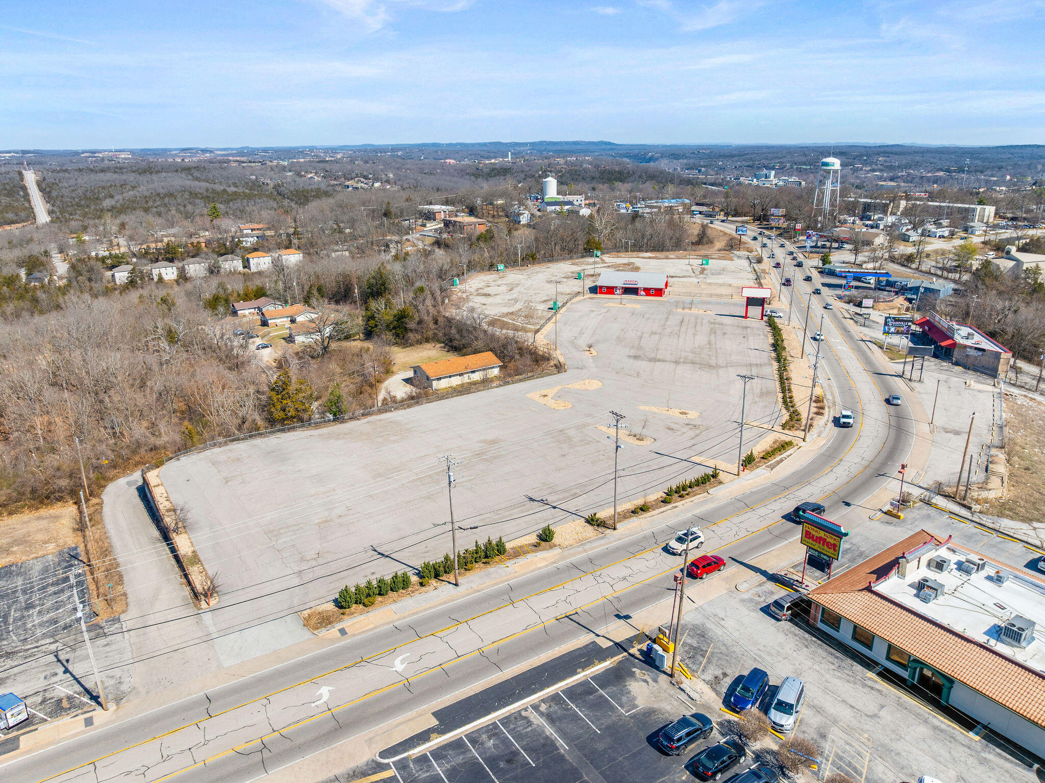Two properties consisting of a combined 10.82 acres being offered for a discounted package price if purchased in 2025. The first property is located at 1157 W. 76 Country Blvd. and it is an 8.35 acre pad site is ready for your next big project. This mostly flat land offers superior visibility and a daily traffic count of approximately 20,000 vehicles. Over $1M in improvements have already been completed with an advanced internal water retention system, paved parking lot and signage. In addition, there's a building structure with ticket retail space, business offices and public restrooms. This is an exciting opportunity to build the next attraction in Branson! The second property is a shopping center located at 1615 W. 76 Country Blvd. It is 2.47 acres of nearly 22,000 square feet of restaurant and retail space on Branson's famous ''76 Strip''. This income producing center is anchored by long-term tenants Fuddruckers on one end and Cold Stone Creamery on the other. Located in a high traffic area next to Dolly Parton's Stampede. This well-maintained, brick-front shopping center also offers newer digital signage and security cameras. Additional MLS #'s 60289005 and 60157071