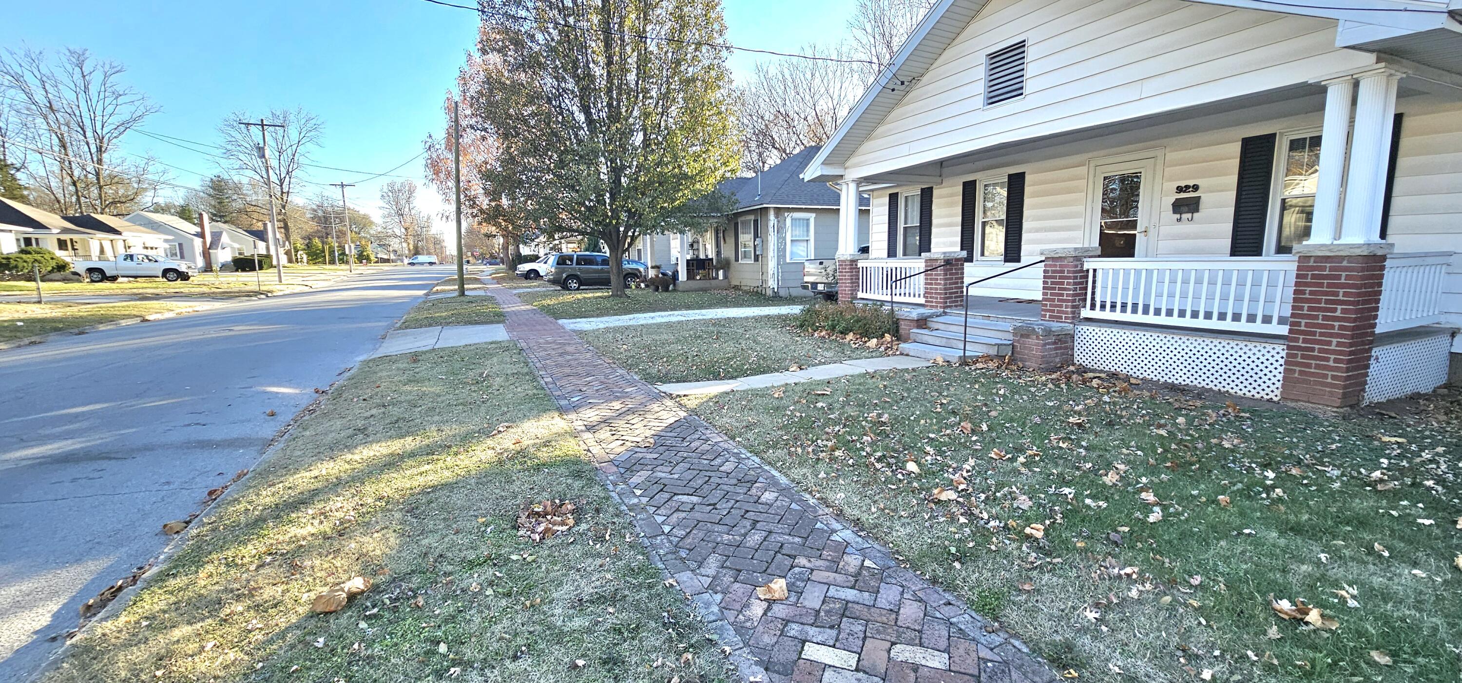 Updated exterior ,blended with 1920's authenticity through out! This has been the home of the current owners since 1960. There is a historical brick sidewalk in front, a detached 1 car garage in back, fenced yard and a deck and patio. 2 BR, 1 bath, appr 1120 sq ft with appr 560 (unfinished)in the basement.The ceilings appear to be 10', with cabinets extending to the ceiling in the ktichen.All wood floors are believed to be original, kitchen flooring is original and many of the fixtures/lighting is original..There is an unfin basement with access near the kitchen and from the exterior. Includes forced natural gas heat, central ac,and woodburing fireplace. The bathroom has been updated and has ''step-in'' access for the shower . The exterior is wrapped with vinyl siding, aluminum soffit/facisa, vinyl windows and a new roof appr 5 yrs ago. Just north of Grand, near Campbell st. Let's not forget the large front porch..porch swing and lemonade could be in your future!..