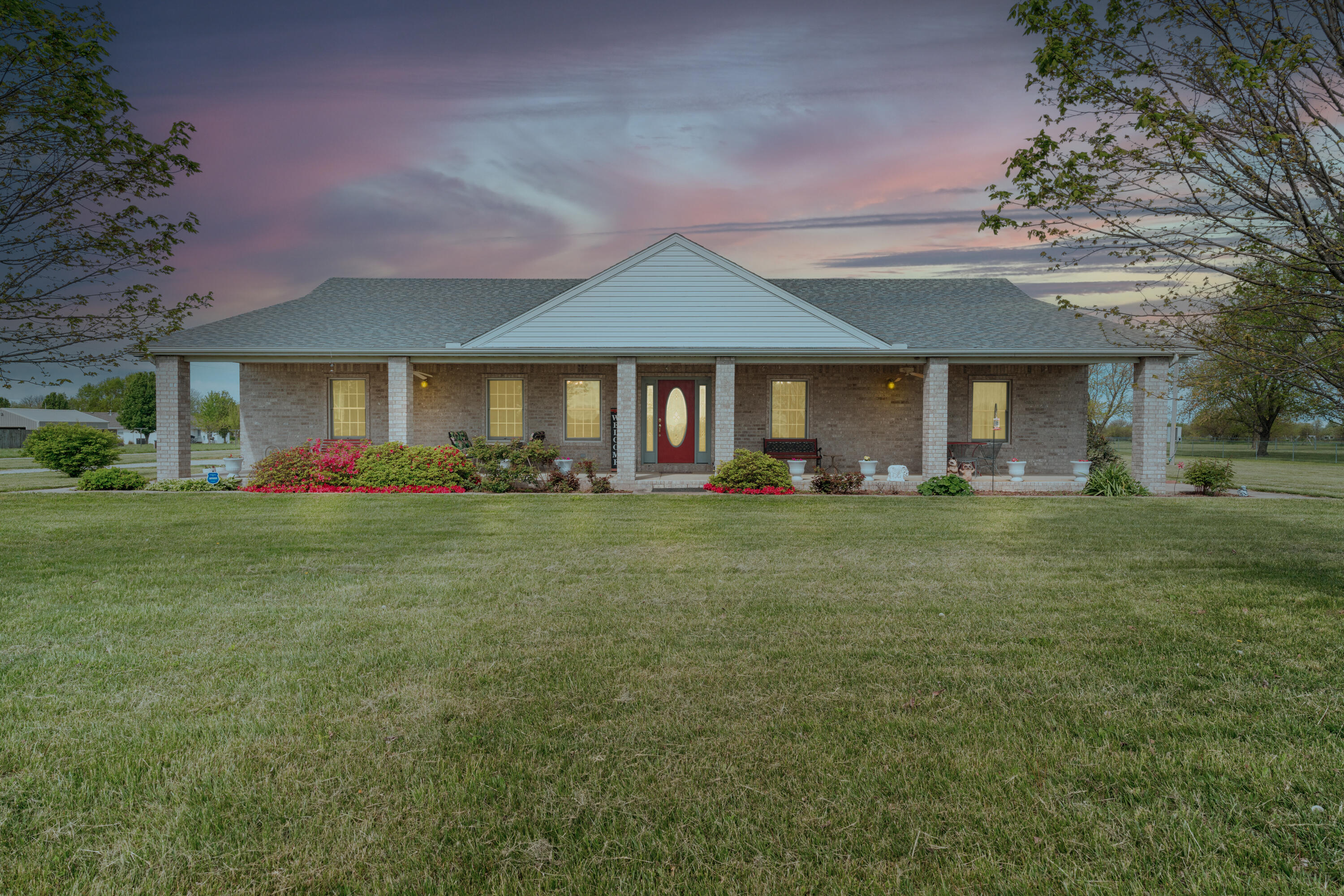 No steps were skipped when the current owners built this ALL brick house in 2005. This meticulously maintained one owner home sits on 3 acres, its 3300 square feet, and has a 40x60 (2400 sq feet) detached shop with concrete floors, oversized garage doors, and even a full bathroom. When these owners built this home 20 years ago they made sure to do it the right way and built it to last using all 2x6 framing and high density spray in insulation to help with energy cost and any outside noise. As you approach the front door you will love the huge front covered porch to watch the sun rise each morning. The interior features beautiful real hardwood floors throughout, 4 bedrooms, 3 bathrooms, a formal dining room, a huge kitchen with a center island and lots of cabinet space, a large living room, beautiful crown molding, tons of storage space including the laundry room, and a full 3 car garage. Some other important features include a generator, an exterior wood furnace building which can heat the whole house, a heated/cooled sunroom, a storm shelter, and this house was built and designed to be handicapped accessible with wide hallways and doorways. This home is absolutely move-in ready from top to bottom and ready for its new owner.