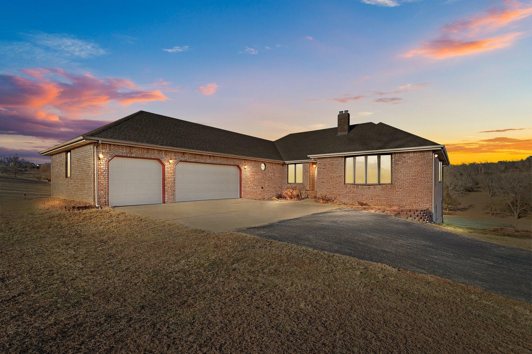 Welcome to over 4,000 sq ft of finished living space in this walk-out basement, all-brick home, set on nearly 7 acres in Ozark! Featuring 6 bedrooms and 3 full bathrooms, this property offers ample space for both relaxation and entertainment. Enjoy 3 distinct living areas, with 2 conveniently located off the kitchen, perfect for hosting gatherings. Car enthusiasts will appreciate the 6 total garage spaces, including a 3-car detached garage equipped with electricity, water, and a 4th door loading bay. The sellers have updated flooring in several rooms and are happy to provide a flooring allowance for any remaining areas. Plus, the refrigerator is included, so you can move right in without the additional expense!