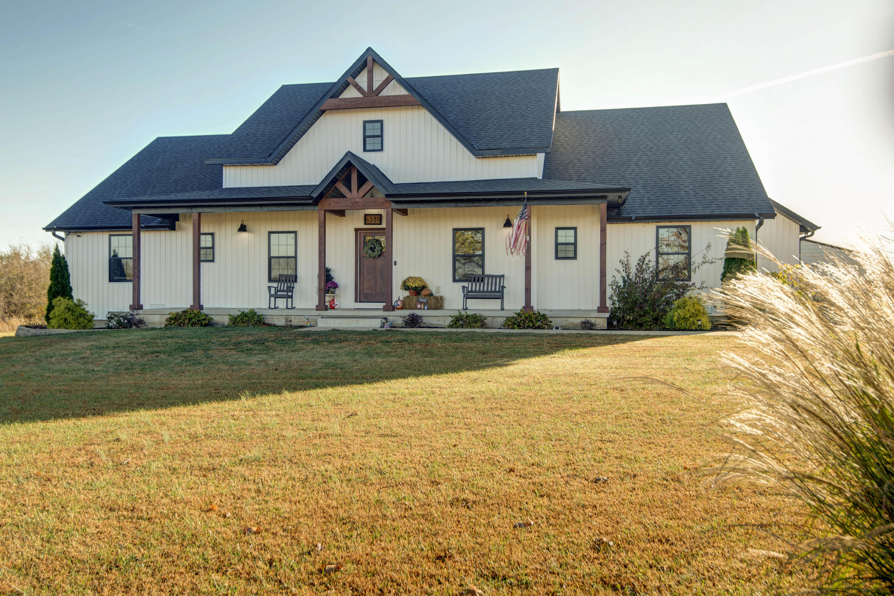 Welcome to your countryside retreat!  Just minutes outside Springfield, this home in Republic is nestled on 4.8 acres.  This stunning modern farmhouse offers the perfect blend of contemporary design and rustic charm.  Featuring a spacious open floor plan with vaulted ceilings, and large windows that fill the home with natural light.  An ideal space for relaxing and entertaining. This 4 bedroom home has large walk-in closets, a jack and jill bathroom and a split bedroom floorplan.  The masterbed/ bath offers a large walk-in shower, free standing tub and cozy up next to the fireplace in the bedroom. The kitchen is stunning! With stainless steel appliances that stay with the home, it also features quartz countertops, a walk in pantry and plenty of cabinet space. Built in 2020 this home also is sold with security alarms, an energy efficient thermostat and a Hot Tub on the large back deck. The 24 x 36 shop with a pull through garage space has a concrete floor and built in shelves, a great space for your hobbies. Outside there is plenty of room for outdoor activities!  Escape TODAY to YOUR peaceful, country living.