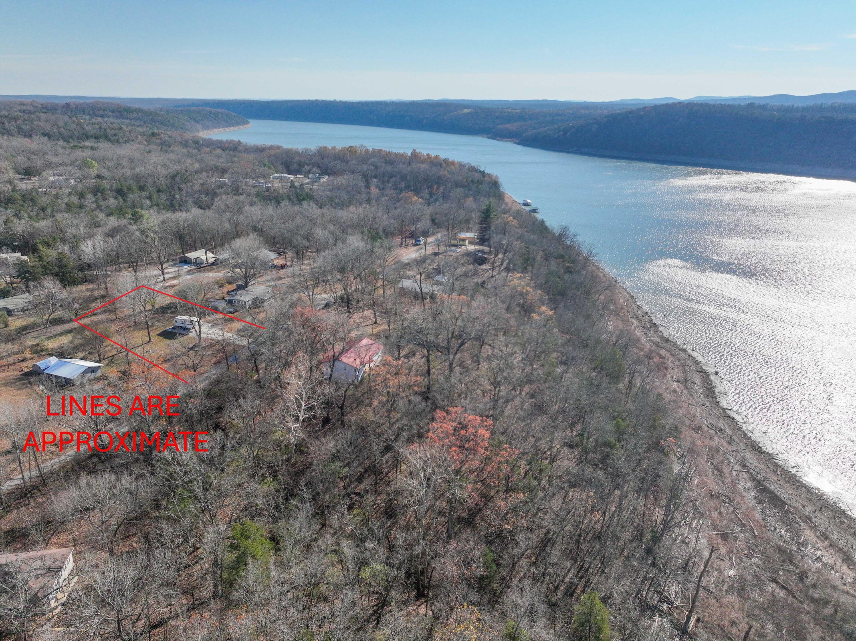 Looking for a lake lot on the beautiful Bull Shoals Lake? This lot comes with all utilities and a small pad ready for your camper. Enjoy easy access to two boat ramps nearby open year-round. K-Dock Marina is located just across the lake for fuel, snacks, and your lake day essentials. Whether you're looking for great fishing or a relaxing time on the lake, this lake offers both. Don't have a camper? The seller would consider selling the camper that is there separately. With Summer just around the corner, now's the perfect time to claim your piece of lake life!