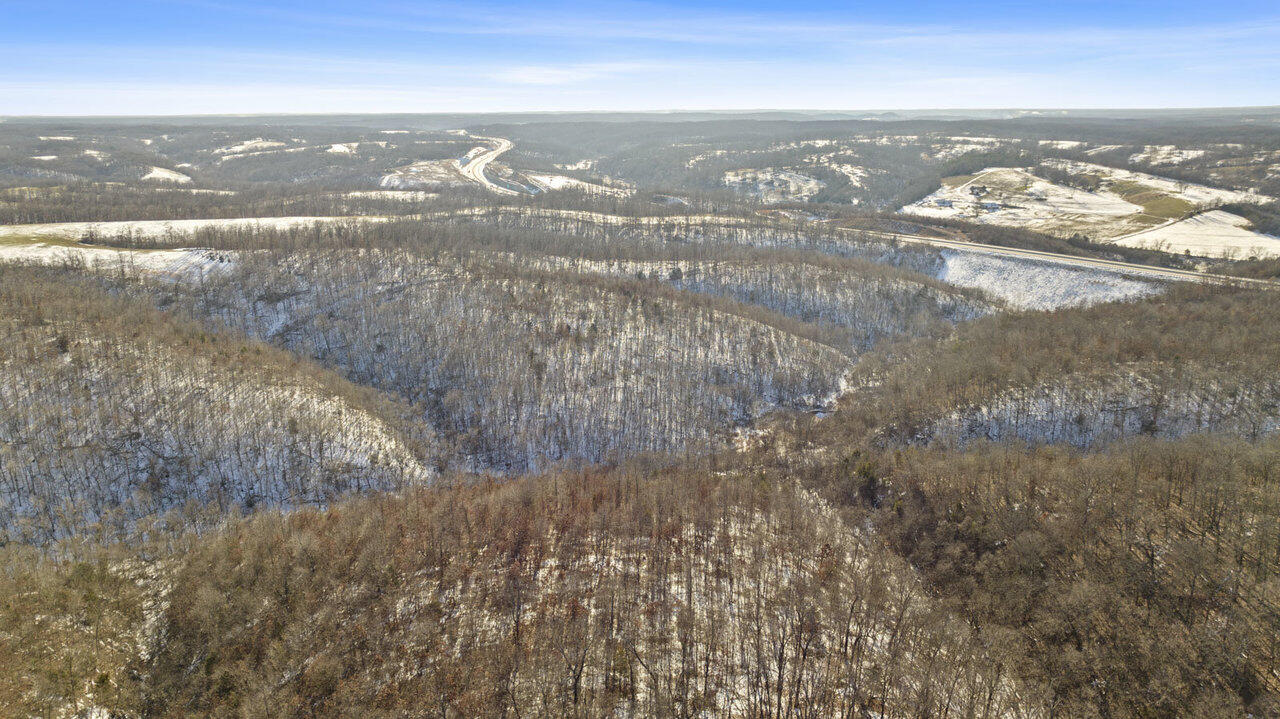New, unique & rare I-49 Interstate Frontage!  Location, Location, Location!  Just minutes to Walmart HQ in Bentonville & Northwest Arkansas, these 72 Beautiful, Rolling Wooded Acres are located directly on the new Interstate 49 / Bell Vista By-Pass in Pineville, MO.  This property is just a couple of minutes north of the recent $22M Blue Crane land purchase on I-49 in Bella Vista which is anticipated to drive SIGNIFICANT growth and investment here in the very near future (see links below).   Incredible opportunity for investors, developers or someone looking for large property for themselves. Subdivide, sell and keep a smaller piece for yourself.   High, visibility area that could be developed commercially or residentially.  NO restrictions!Close to Hwy 71 junction connecting Jane, MO & Bella Vista, AR.  Enter property through easement on Sugar Valley Circle, Pineville, MO.  Join the growing movement & investments happening in beautiful Pineville, McDonald County, Missouri.  Priced to move with motivated sellers.  Make an offer!