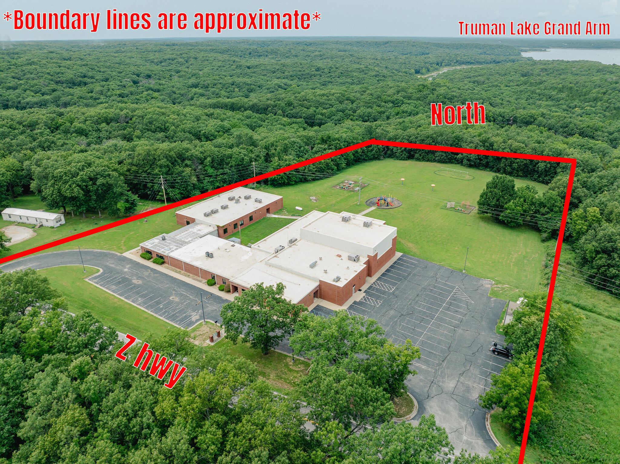 SELLER IS NEGOTIABLE FOR ANYONE INTERESTED IN ADDING MORE LAND TO THE TRANSACTION! Once-in-a-lifetime real estate opportunity in the Truman Lake area! Located in in the heart of the Ozarks between Clinton and Warsaw, sits a roughly 32,000 square foot school building on 5.9+/- acres with many updates and numerous use options. Of course, the amenities you'd expect with a school are included - such as a spacious gymnasium, full-service cafeteria equipped with a large walk-in cooler and freezer, and an abundance of classrooms, bathrooms, showers, and office spaces. Three of the classrooms have been thoughtfully converted into flexible spaces that can function as offices or living quarters, potentially offering up to 15 private spaces with bed accommodations. The fully paved parking lot ensures convenient access for students, staff, or patrons. Four newly renovated shower stalls are located in the west wing, adding to the building's versatility, along with a total of nine bathrooms, comprised of three boys, two girls, and four any gender restrooms. 12 fully functional classrooms, most equipped with water hook-ups for sink installations, and many are set up with projectors. A dedicated utility room is available with hook-ups for four sets of washers and dryers. The large library would be a great common area or game room. Many rooms throughout the facility include new flooring and modern windows, enhancing the building's overall appeal and energy efficiency. Ample storage rooms are located throughout the building, providing more than enough space for supplies, equipment, or inventory. Importantly, there is no county zoning for this property, which opens countless use possibilities for any new owner. Use as a traditional or specialized school, or convert to healthcare, event space, office space, residential, or retail.