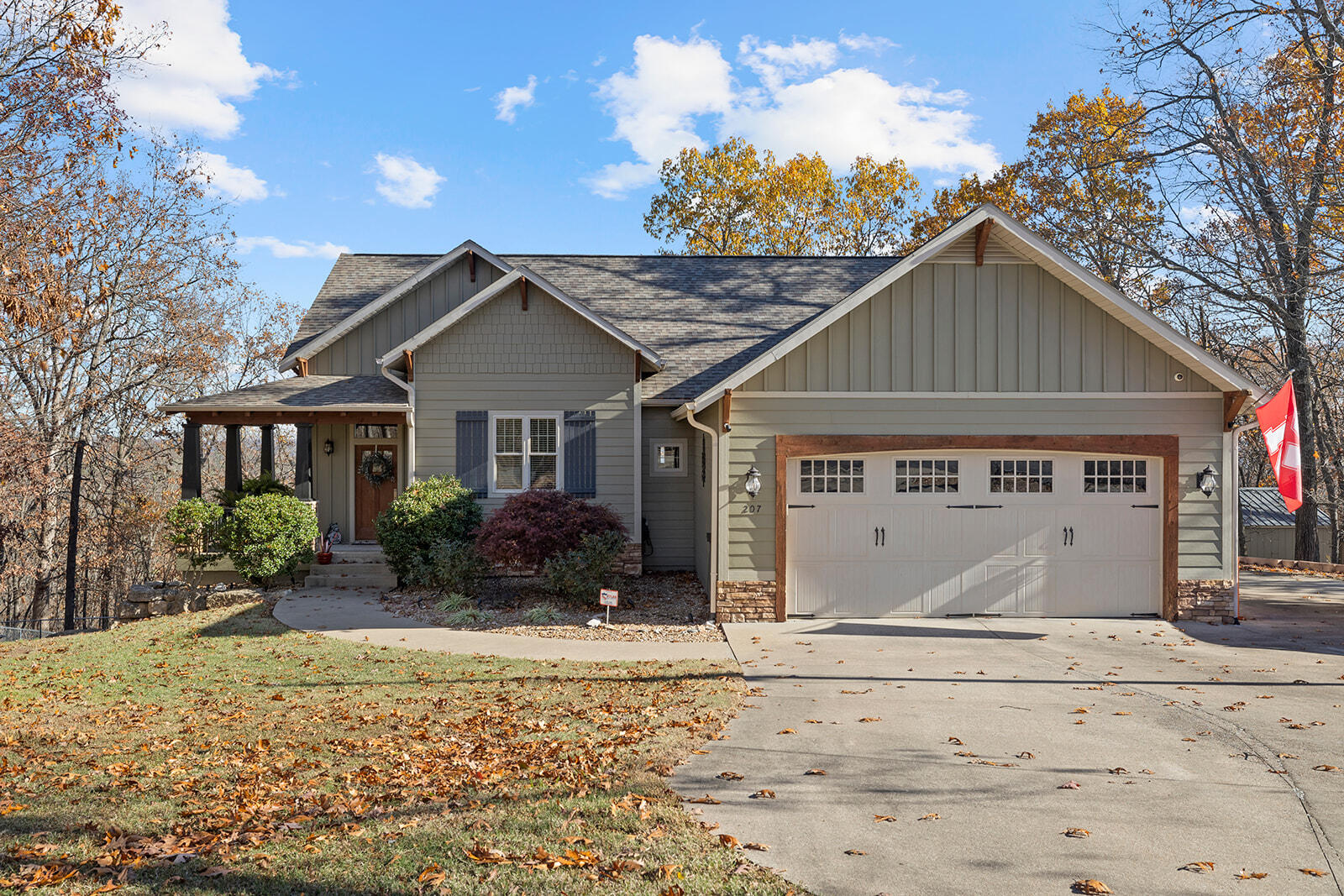 Welcome to 207 Red Rose Ln! This gorgeous lakeview home offers so many wonderful features. Ask your agent for the list of updates and special features. Situated on 2.7 private wooded acres with. This home features 3 bedrooms and 3 full baths PLUS a 4th nonconforming bedroom downstairs. Tons of storage. Main floor master and main floor laundry. 2 living areas, 2 gas fireplaces, updated bathrooms, 2 massive decks and wired for a hottub, John Deere room, new heat pump, fenced in dog run, extra parking on side of the house with 40' RV pad with full hookups. New  insulated shop added in 2019 with mini split AC. Located 10 min from Baxter Marina for all your boating and lake activities, 5 min from Kimberling City shopping, 25 min to Silver Dollar City, and 35 min to Branson.