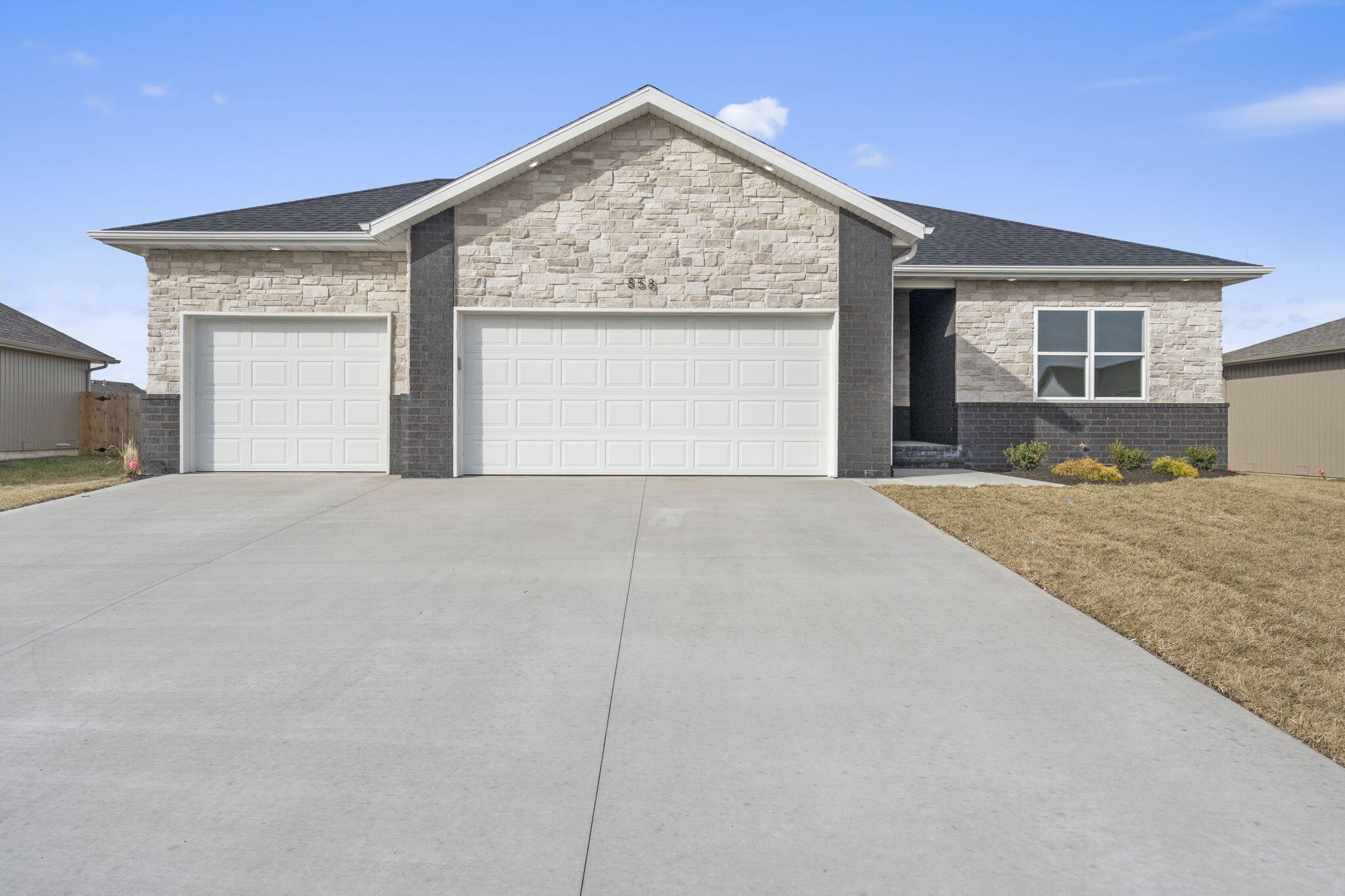Located in one of Nixa's most sought-after neighborhoods, this stunning new construction seamlessly blends modern elegance with thoughtful design. Featuring three spacious bedrooms, two beautifully finished bathrooms, and an open, split-bedroom floor plan, this home is built for both comfort and style. The heart of the home is a chef-inspired kitchen, complete with custom cabinetry, sleek granite countertops, a charming coffee bar, and a hidden walk-in pantry for added convenience. Luxury vinyl flooring flows throughout, adding both durability and sophistication. The expansive three-car garage provides ample storage, while the back deck offers the perfect setting for outdoor relaxation and entertaining. The fully sodded yard, equipped with a sprinkler system, ensures effortless maintenance. Every detail of this home has been carefully crafted to enhance your lifestyle.