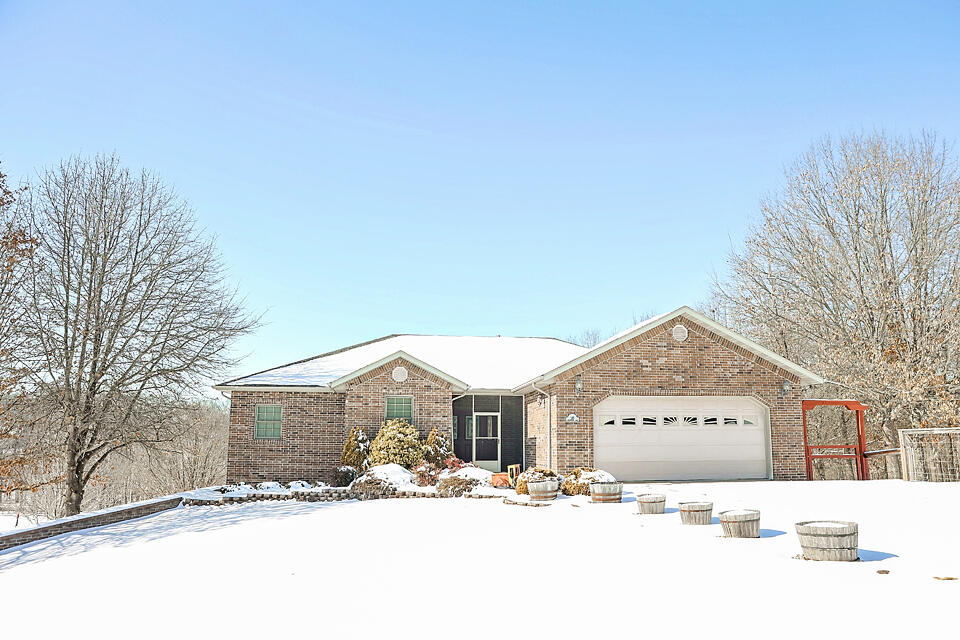 Welcome to Your Dream Home - Where Country Charm Meets Modern Luxury!Nestled on 4 tranquil acres, this custom-built retreat seamlessly blends space, privacy, and modern convenience. Perfect for those seeking both peace and functionality, this home offers an abundance of features designed for comfort, versatility, and style.Inside, you'll find 6 spacious bedrooms, 3 bathrooms, and two separate living areas--ideal for multi-generational living or hosting family and friends. The open-concept design allows natural light to flow effortlessly throughout the home, accentuating the high-quality craftsmanship and thoughtful layout. The buried/owned 500 gal propane tank feeds the automatic/on-demand generator which adds peace of mind, providing continuous power during outages.Notable Features:Oversized 3-Bay Detached Garage & Workshop: A standout feature of the property, the 1,800 sq. ft. detached shop comes complete with air conditioning, radiant floor heat, hot water, and a 3/4 bathroom--ideal for your hobbies, projects, or business needs.Radiant Floor Heating: Stay cozy year-round with radiant floor heating installed in the basement and detached shop.Additional Living Space: A non-conforming room offers endless possibilities--perfect for a home office, gym, playroom, or craft space to suit your lifestyle.Storm Shelter: For added peace of mind, a small solid-concrete storm shelter room is located in the basement, ensuring safety during severe weather.Hickory Floors & Cabinets: Stunning craftsmanship and the beauty of solid hardwood is readily evident in solid hickory kitchen cabinets and main level flooring.Outside, enjoy the best of country living with plenty of room for gardening, outdoor activities, or simply soaking in the stunning views. Whether you're gardening, enjoying a quiet evening, or hosting gatherings, this home offers the ideal setting.This exceptional property truly has it all! Don't miss out, schedule your showing today!