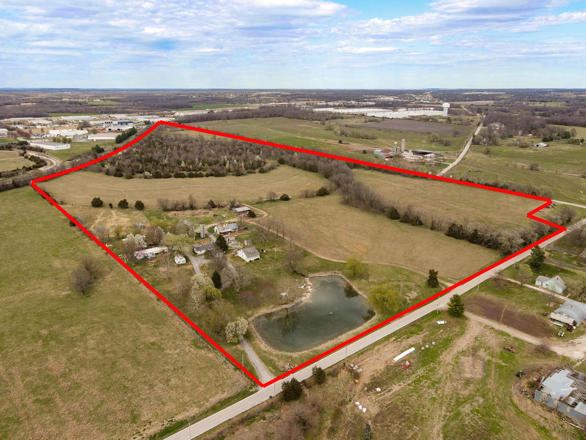A once in a lifetime property! Exceptional 67+ acres of prime land ready for development, with endless possibilities! Numerous commercial, industrial and residential developments in the area. Located in the rapidly growing & multifaceted NE section of Springfield MO - East of Hwy 65 with Farm Rd 116 road frontage on two sides. This large piece of level land combines beautifully manicured cleared/pasture (approx. 70%), and mature timber/wooded acreage (approx. 30%) creating a perfect setting for your ideas. Just one of the many special traits of this property is the Spring fed Private Lake which was one of the main water sources for the Historic Trail of Tears. Surrounded by weeping willows; pear trees; magnolia and dogwood trees (to name a few), providing an array of picture worthy views.The land is currently zoned AG but has Industrial bordering it on 2 sides. Including Main Railway Tracks running along the back /North boundary, which is across the tracks from SRC, SMC Packaging Group & Digital Monitoring Products.Situated in an area experiencing a blend of residential, industrial, and commercial developments, reflecting the region's growth and diversification.This property has been protected, maintained, and adored by the same family for generations, and they are excited to see what the next owner has in store.