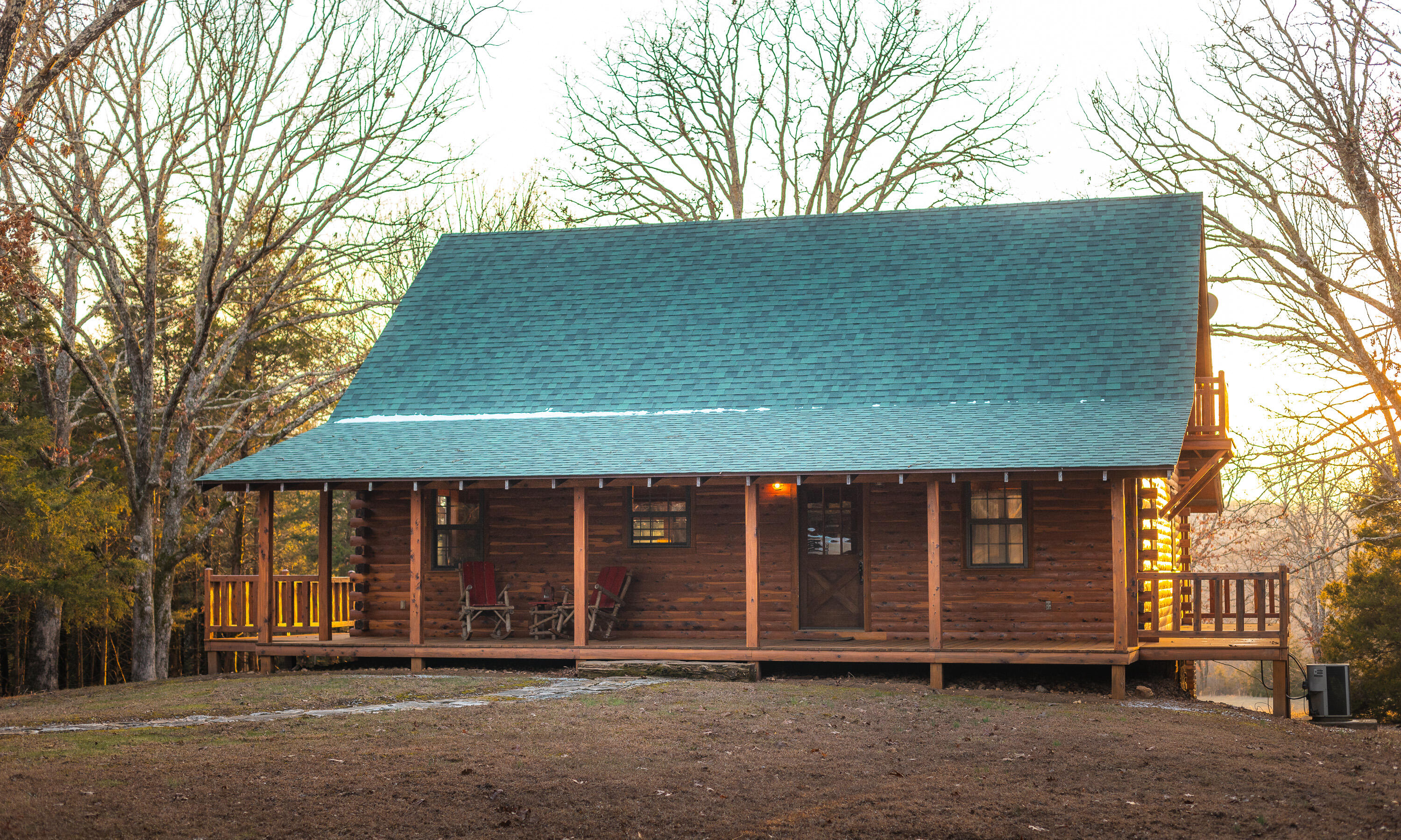 Nestled just minutes from town and easily accessible off a paved highway, this 87 acre property offers the perfect balance of convenience and seclusion. Hidden from the world, it features over 1/4 mile of crystal-clear Hog Creek, providing a peaceful backdrop for recreational activities like fishing, swimming, or simply enjoying the beauty of nature. The custom-built cedar lodge spans over 2,100 sq ft and showcases true craftsmanship. With pine floors, custom beams, and elegant black iron railings, every detail of this home has been thoughtfully designed. The spacious layout includes 3 bedrooms and 2 full baths, offering both relaxation and ample space for entertaining. Whether you're relaxing on the expansive front or back deck, the home offers the perfect spots to unwind while soaking in the natural surroundings. Tucked away in a grove of towering cedars, the lodge provides privacy while still being conveniently close to town and all necessary amenities. Beyond the home, the property boasts a 40x60-foot all-steel shop building, equipped with electricity and double 12-foot lean-tos, plus a bathroom--perfect for storing equipment.