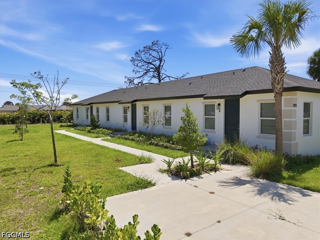 Contemporary duplex exterior featuring white stucc