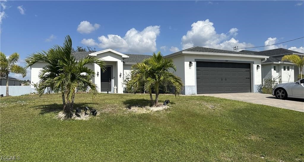 Ranch-style home with a front lawn, stucco siding,