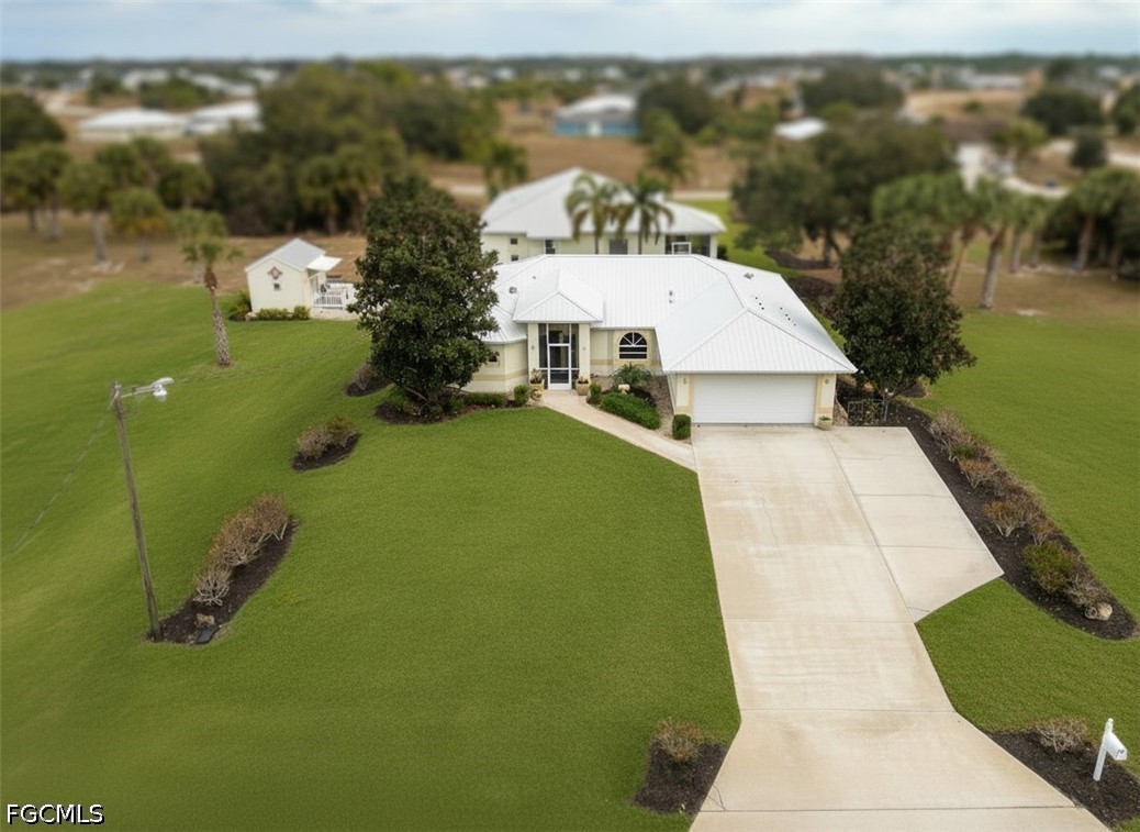 View of front facade with stucco siding, driveway,