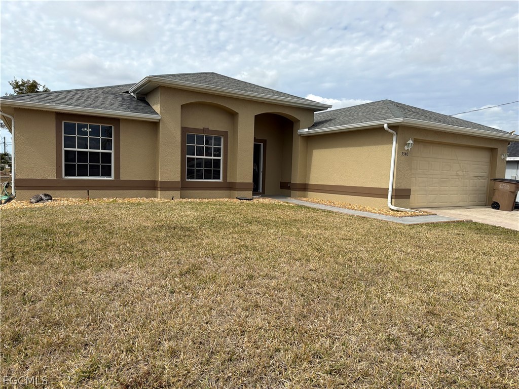 View of front of house featuring stucco siding, a