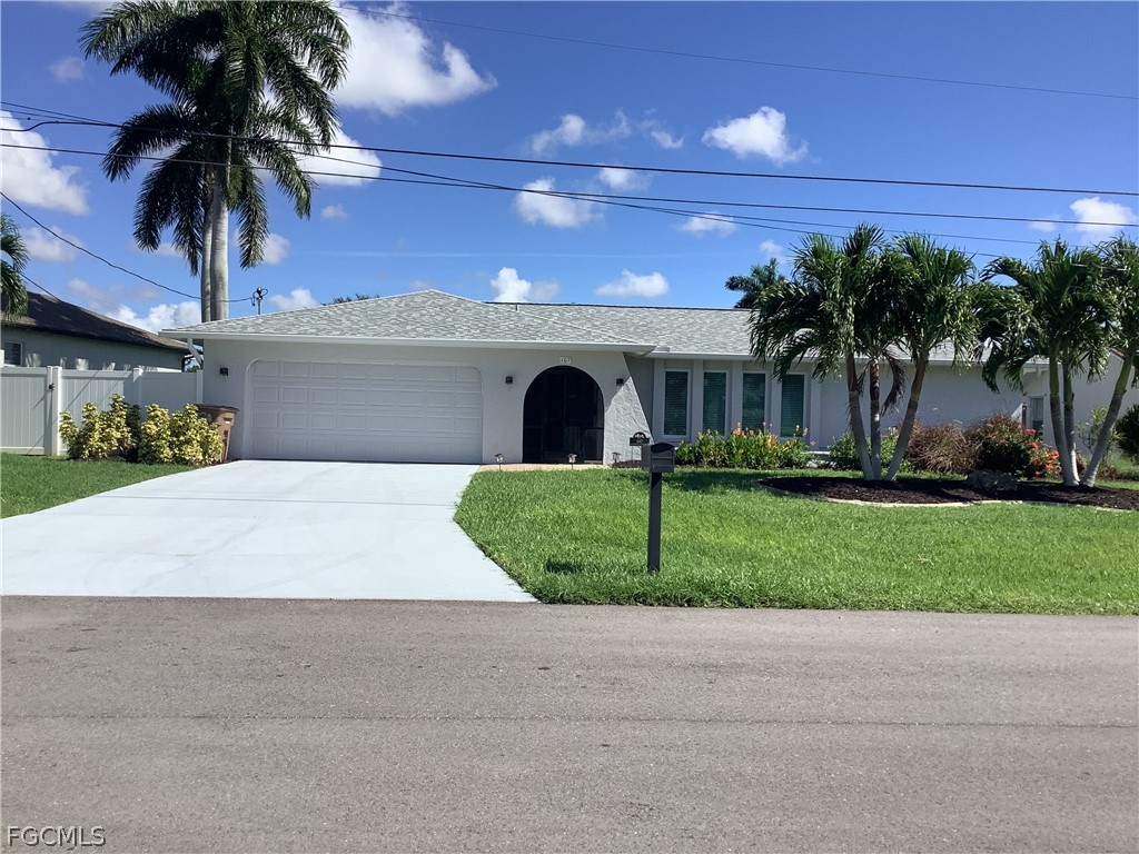 Single story home featuring an attached garage, st