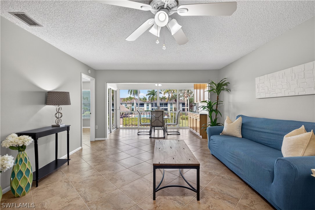Living room with views of the pool and courtyard,