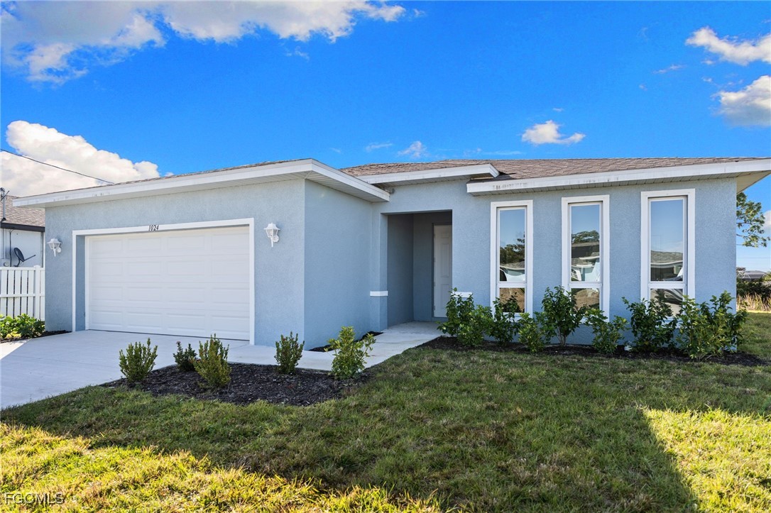 Ranch-style house with a front lawn, stucco siding