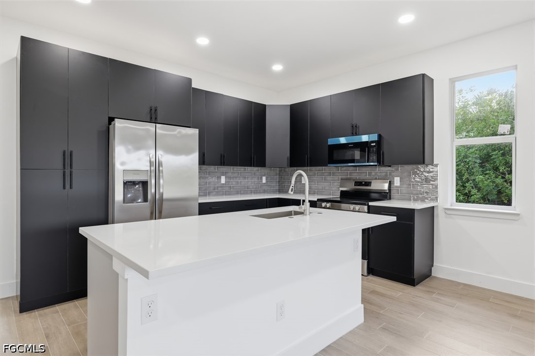 Modern kitchen featuring a large center island wit