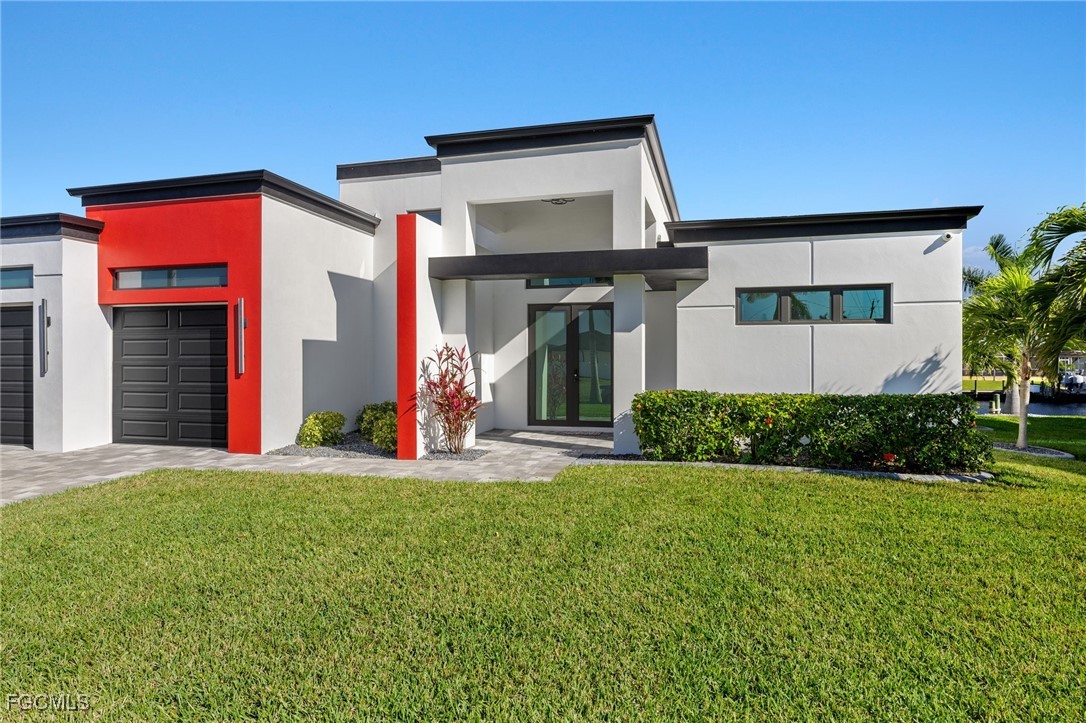 Contemporary home with a front yard, stucco siding