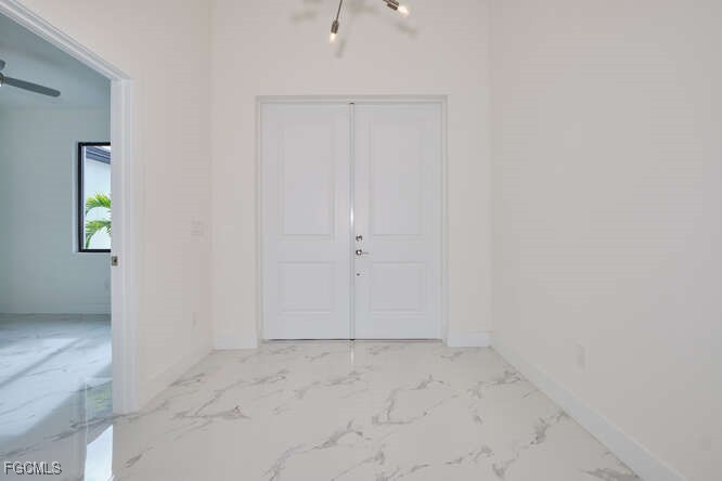 Entryway foyer with light marble finish flooring a