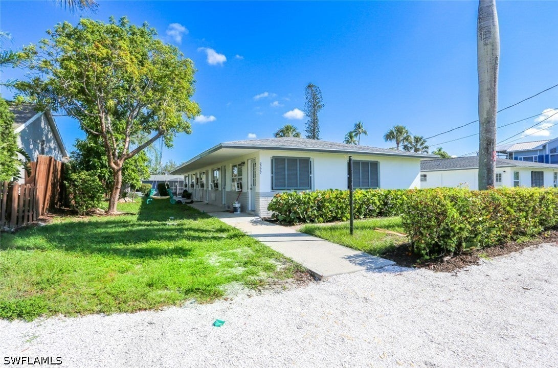 Single story home with a front lawn