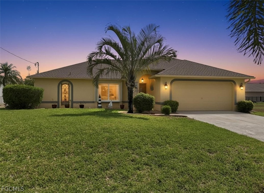 View of front of home with stucco siding, a garage