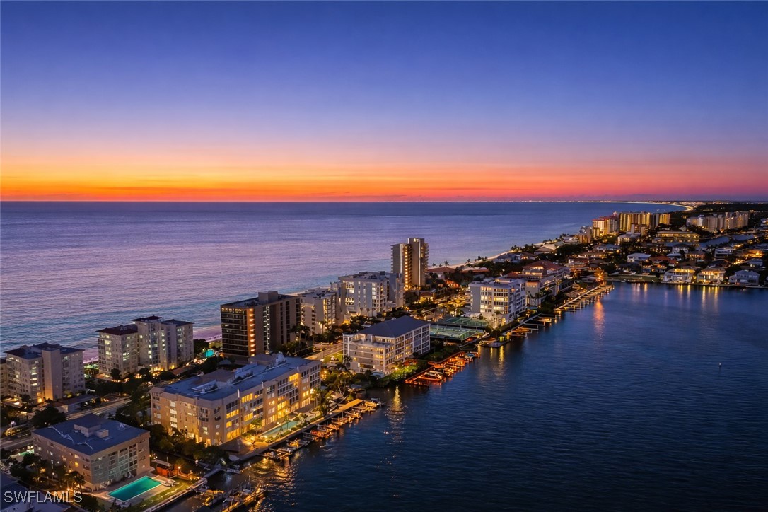 Aerial view at dusk of a water view and a city vie