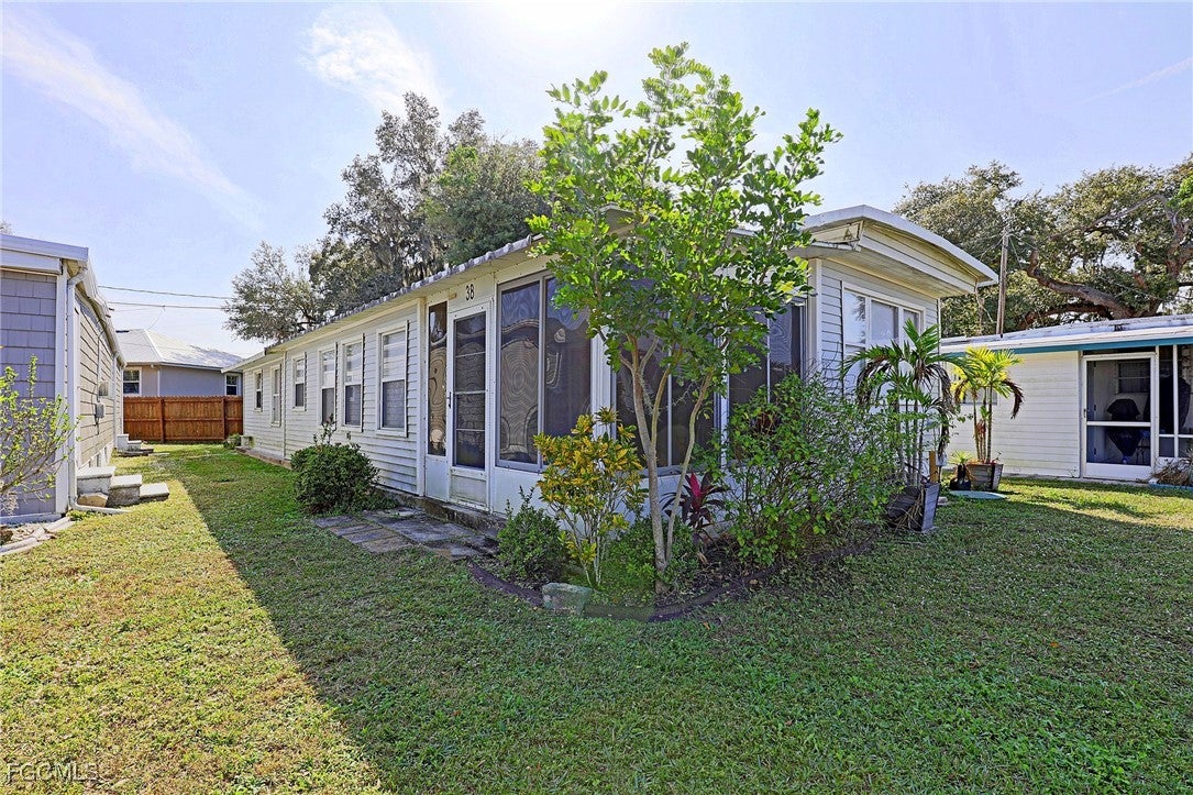 View of property exterior with a sunroom
