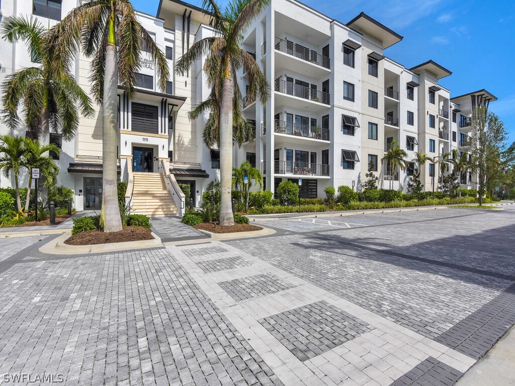 View of apartment building / complex featuring sta